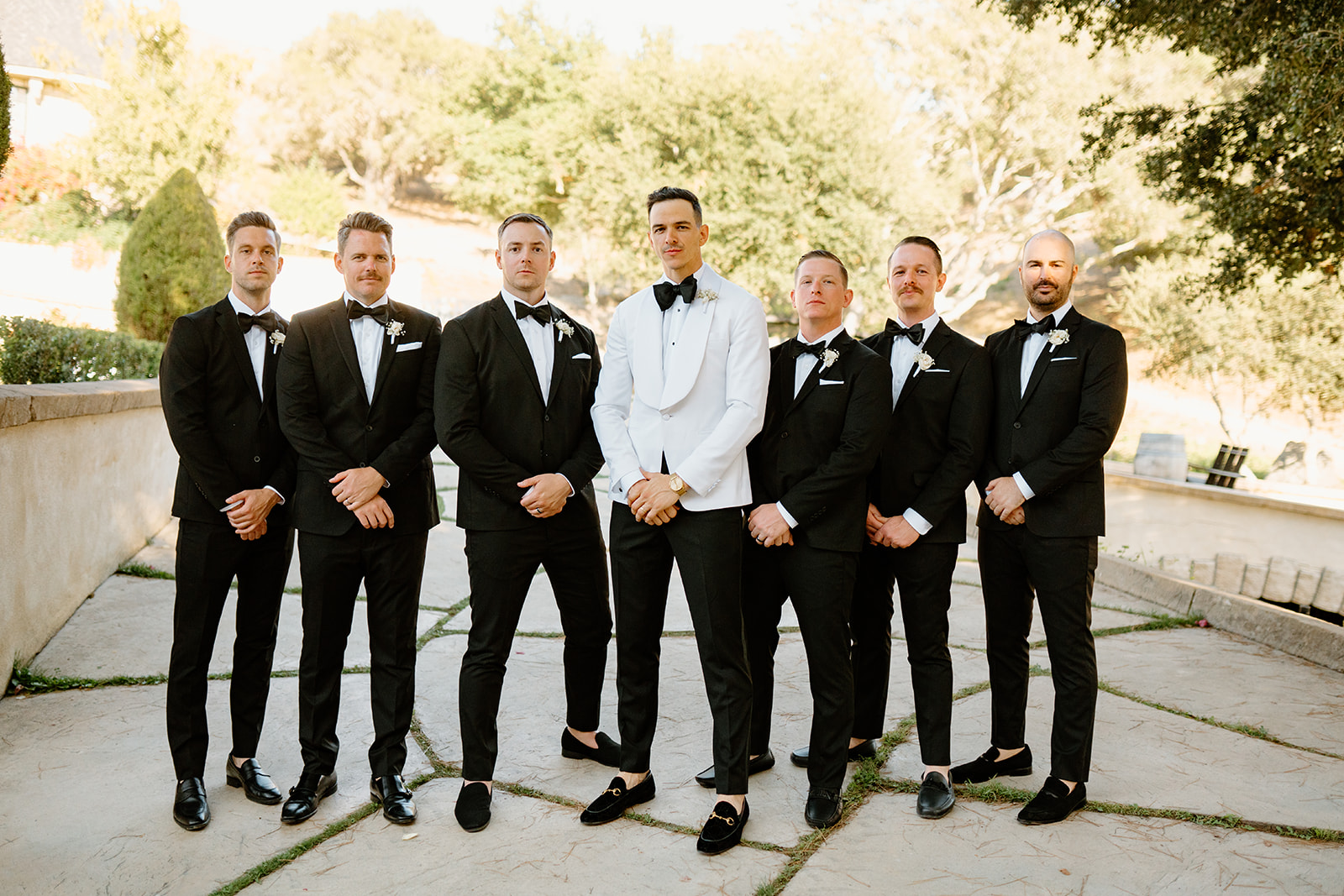 Groomsmen party cheers at Chateau Noland wedding in San Luis Obispo California - Cobblestone
