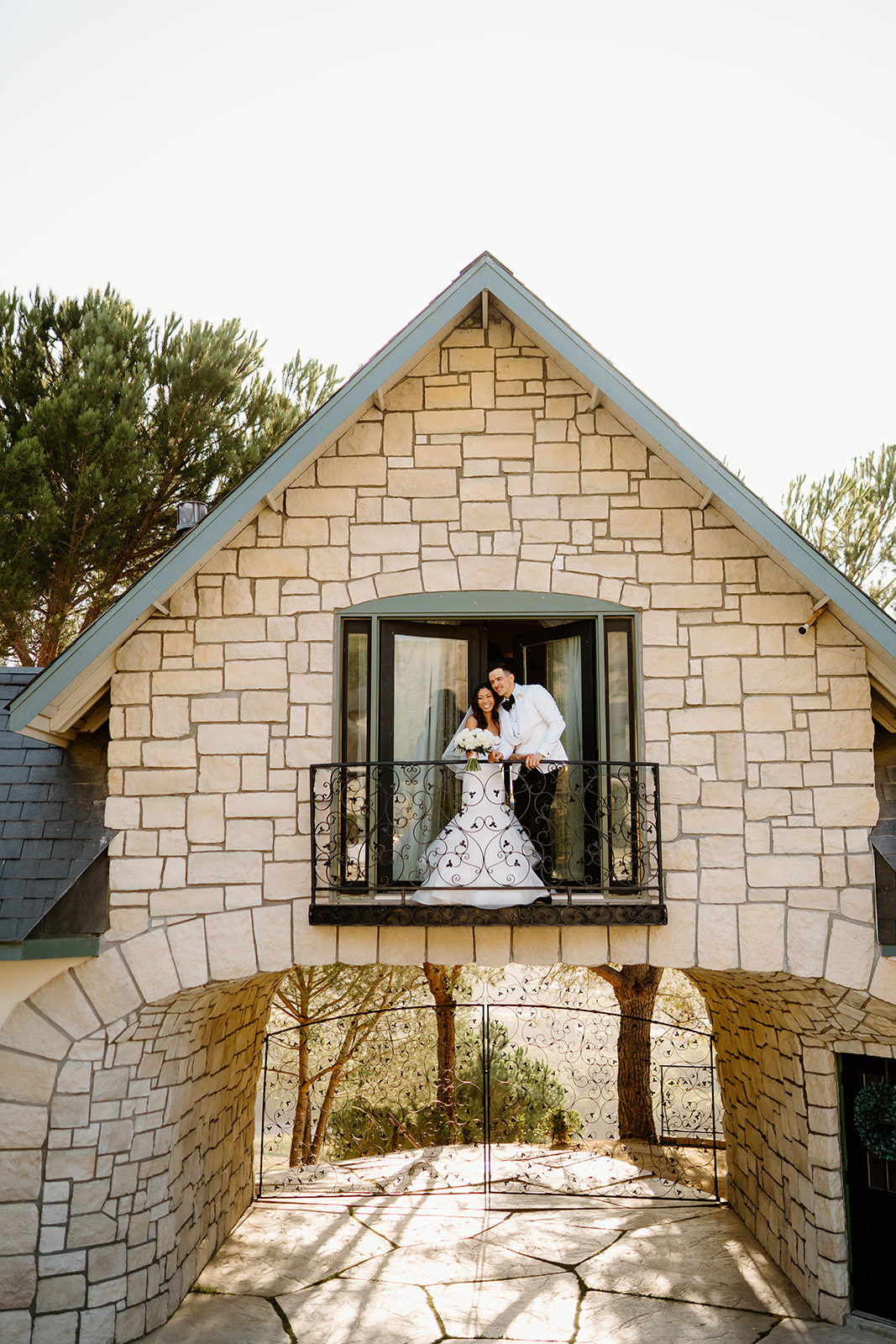 Bride and groom on balcony during wedding at Chateau Noland in San Luis Obispo California - Cobblestone