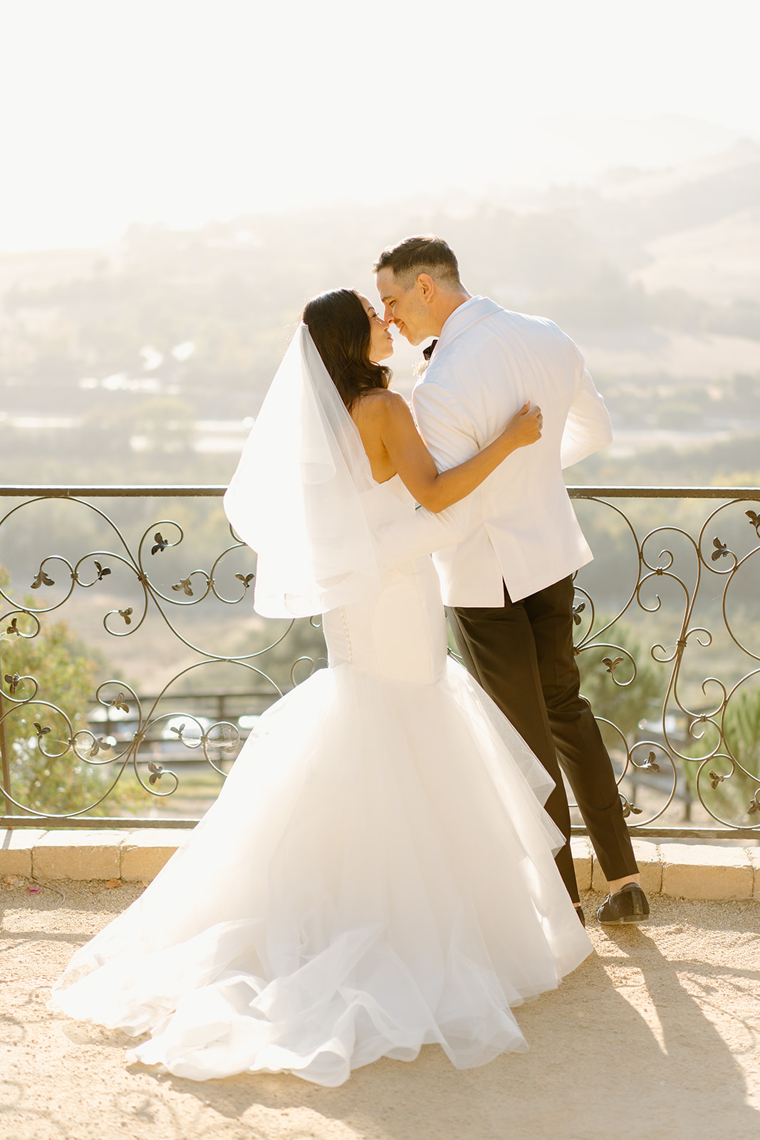 Bride and groom kiss at Chateau Noland wedding in San Luis Obispo California - Cobblestone