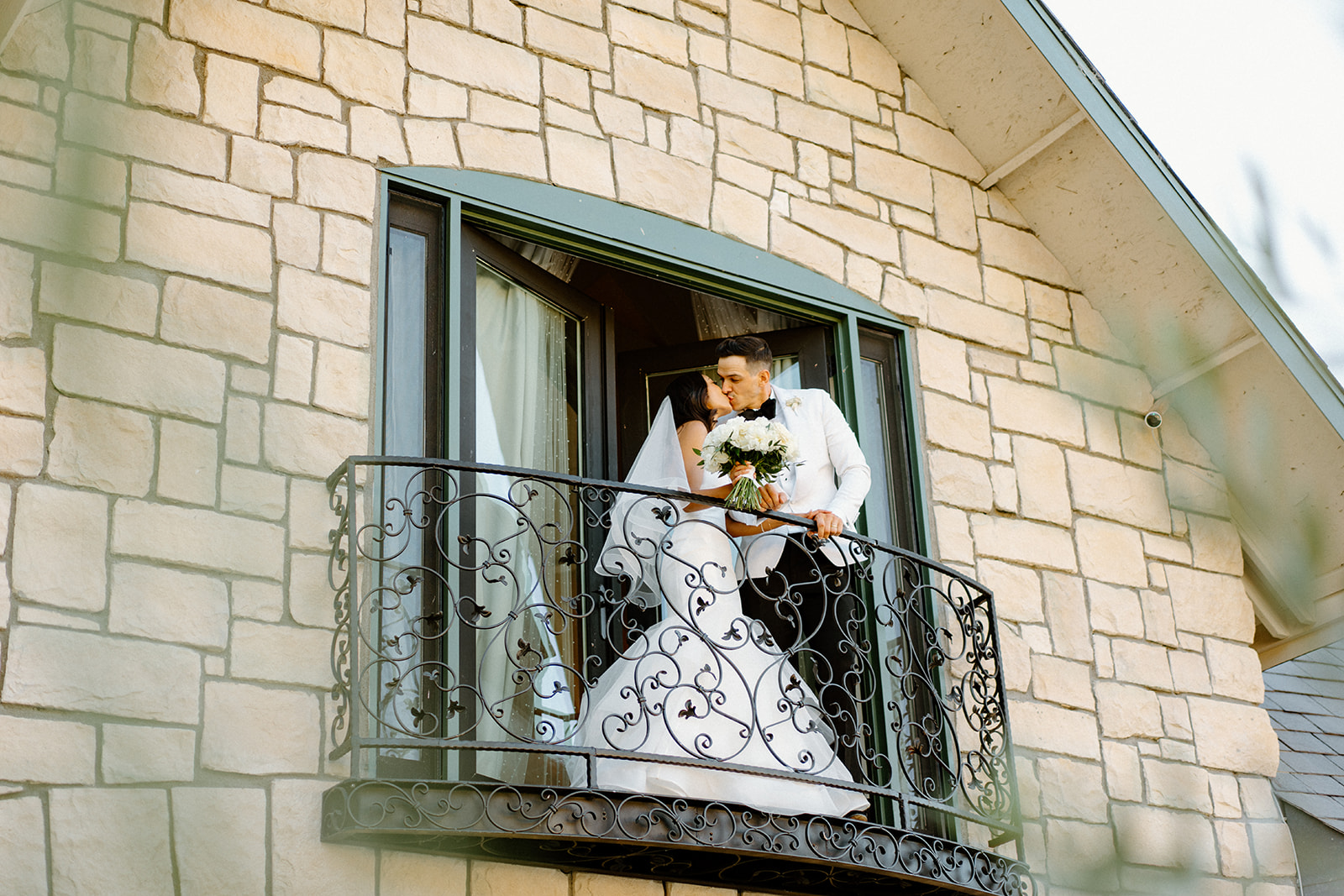 bride and groom on balcony during wedding at Chateau Noland in San Luis Obispo California - Cobblestone