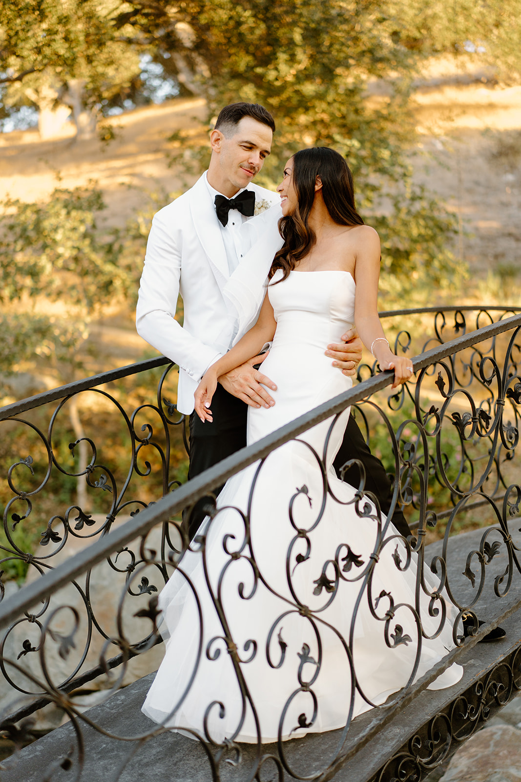 Bride and groom cross bridge at Chateau Noland in San Luis Obispo California - Cobblestone