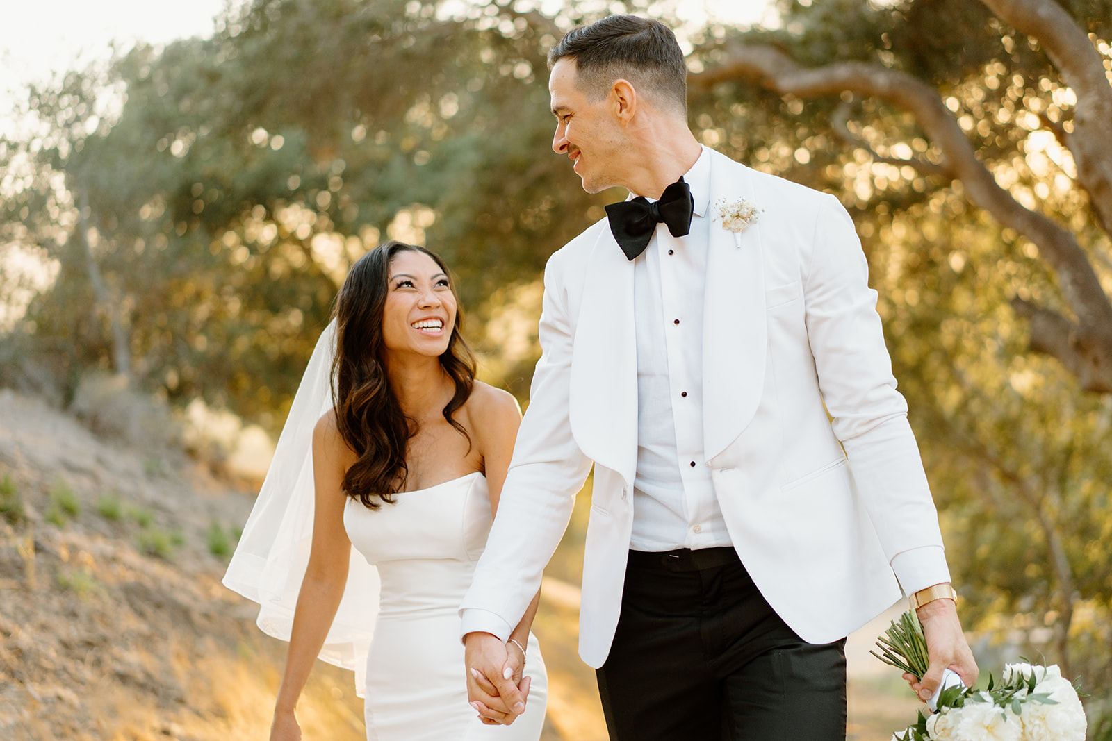 Bride laughs at groom during wedding at Chateau Noland in San Luis Obispo California - Cobblestone