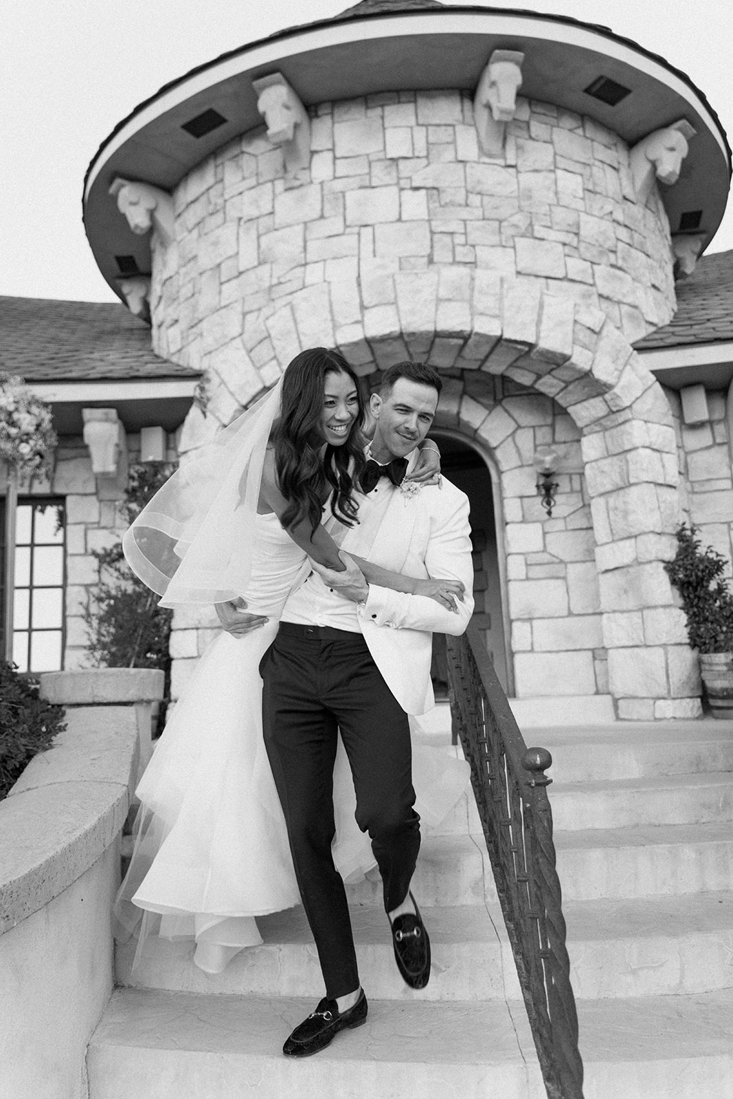 Bride and groom walk down steps at Chateau Noland In San Luis Obispo California