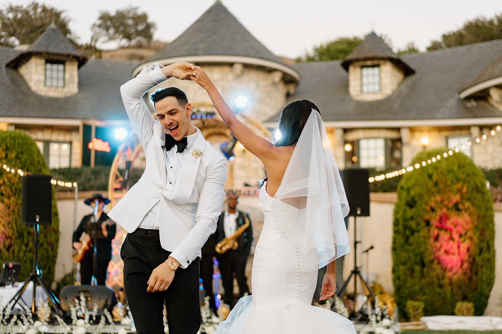 Groom gets a spin from bride during wedding at Chateau Noland in San Luis Obispo California - Cobblestone