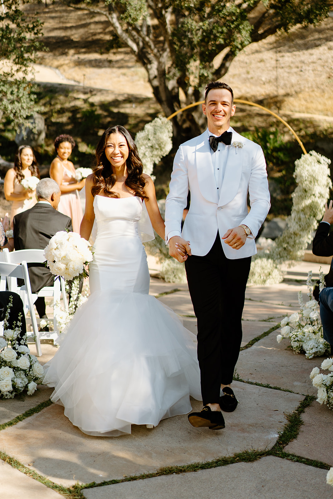 Bride and groom walk down the isle at Chateau Noland wedding in San Luis Obispo California - Cobblestone