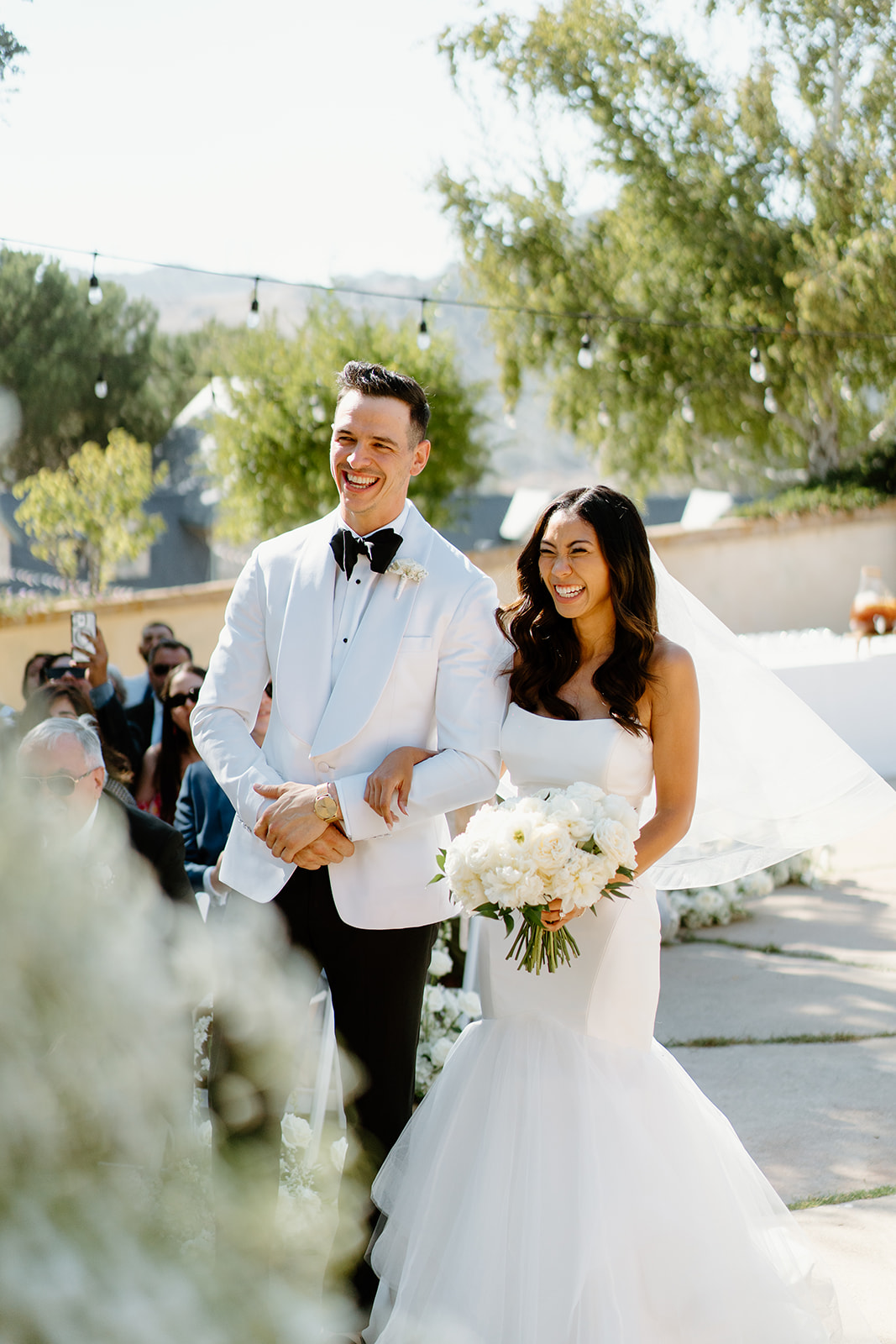 Bride and groom walk down the isle at Chateau Noland wedding in San Luis Obispo California - Cobblestone