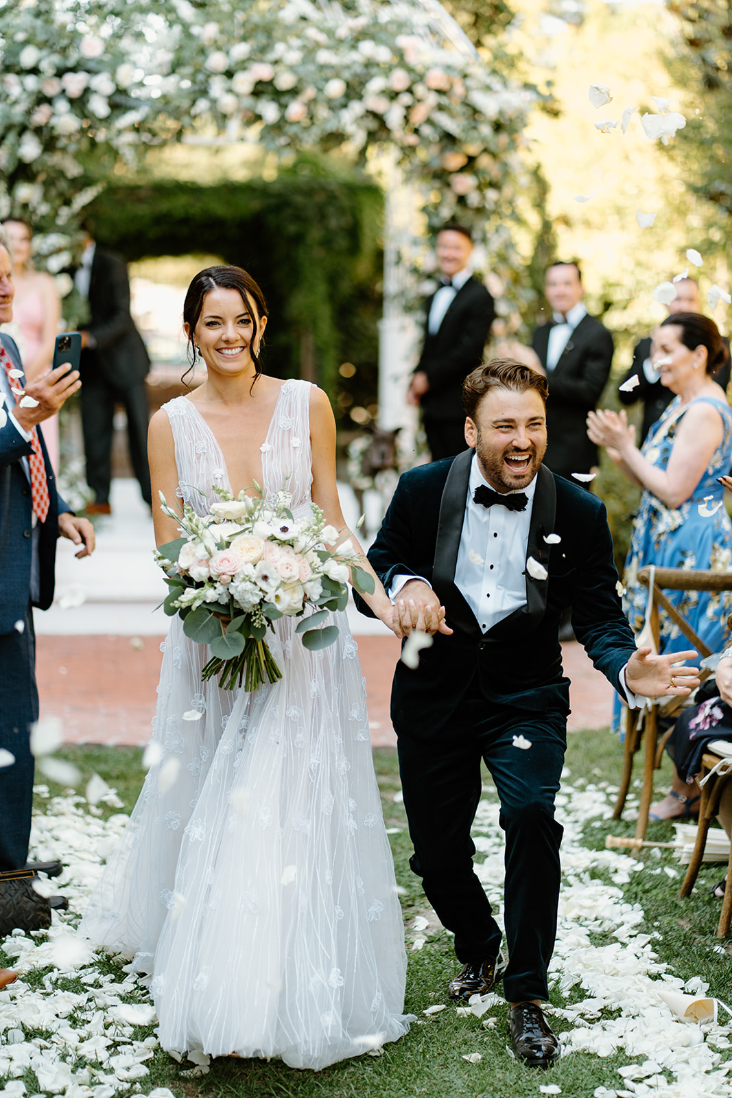 bride and groom walk down the isle at 1880 Union Hotel in Los Alamos, Ca photography by Cobblestone
