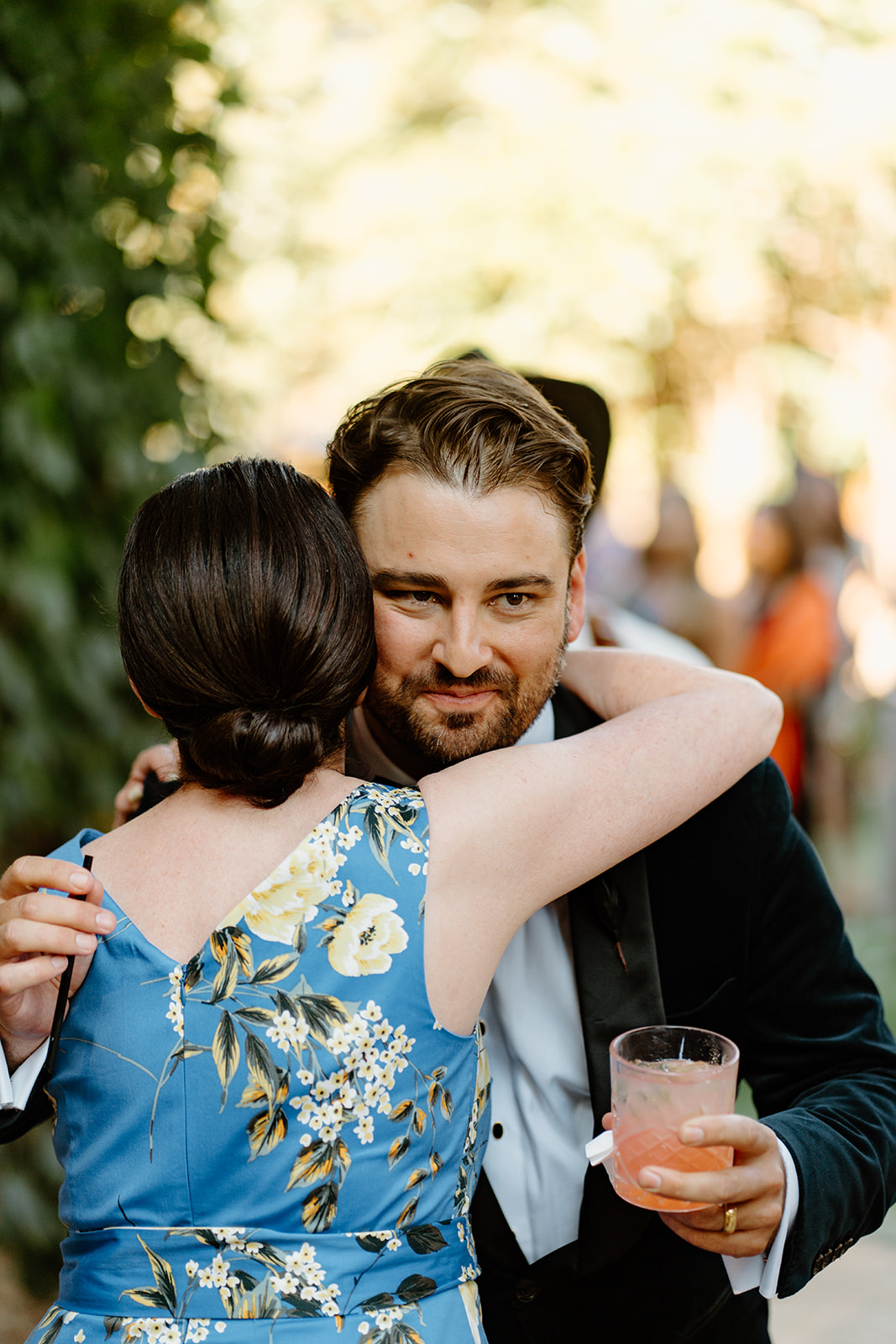 groom with drink hugging guests at 1880 Union Hotel in Los Alamos, Ca photography by Cobblestone