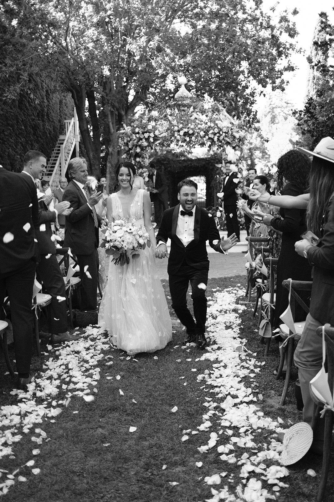bride and groom walk down the isle at 1880 Union Hotel in Los Alamos, Ca photography by Cobblestone