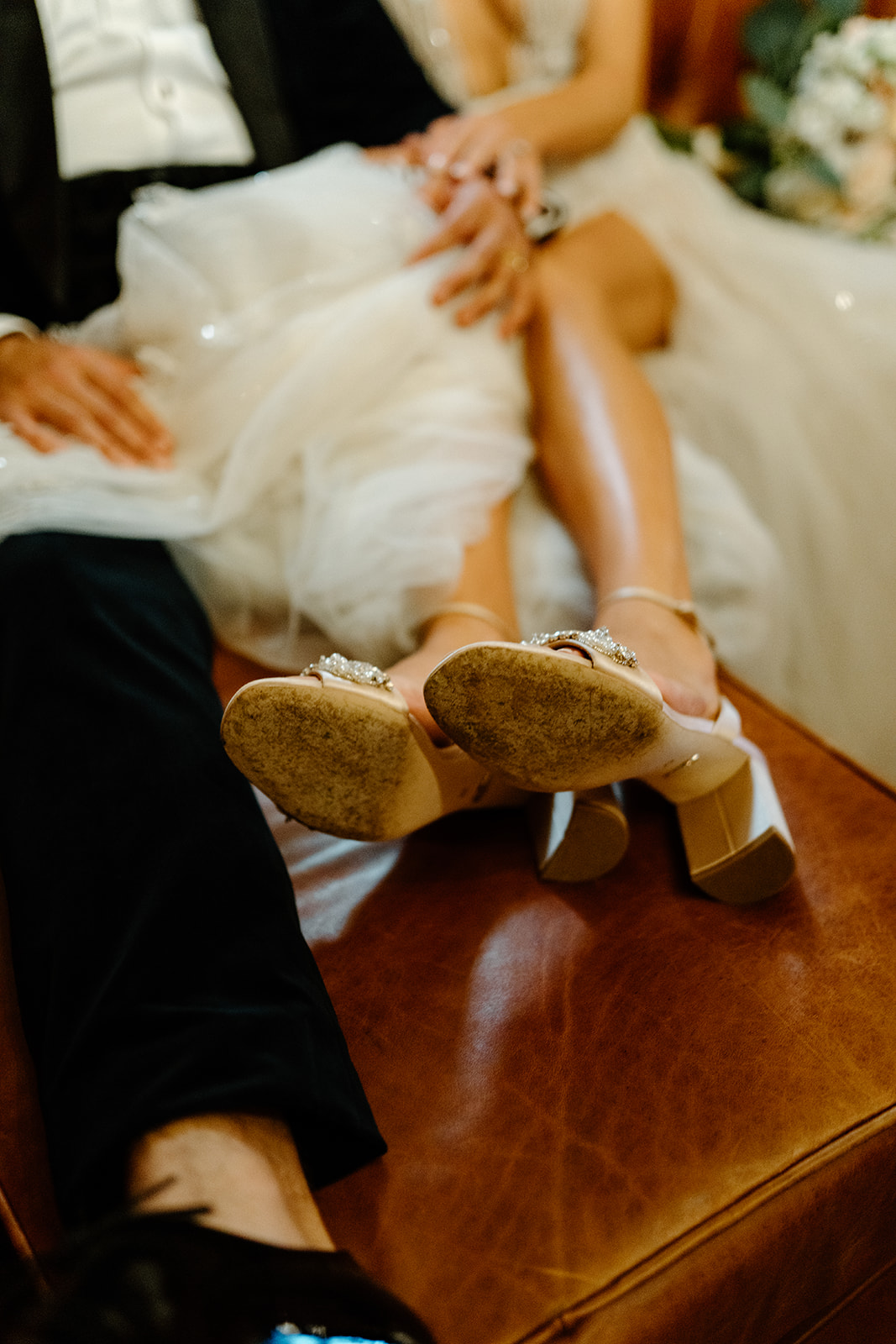 bride and groom cuddle on couch at 1880 Union Hotel in Los Alamos, Ca photography by Cobblestone