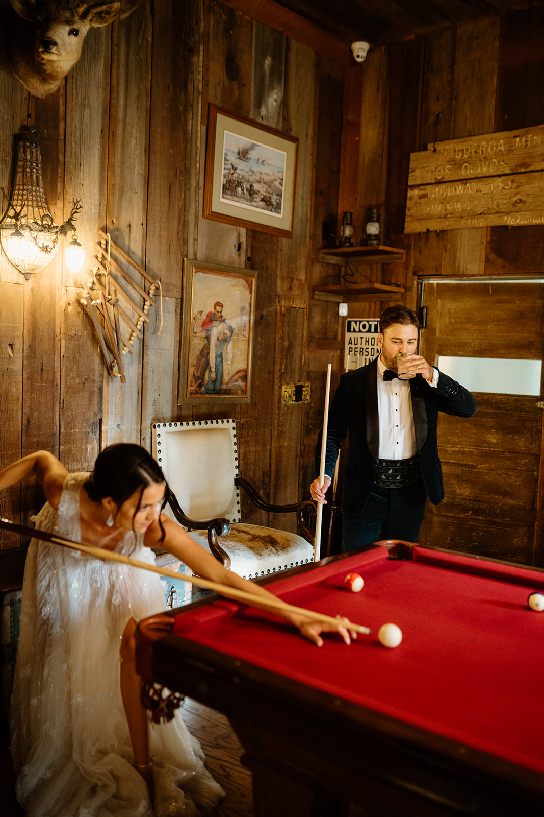 bride and groom play pool at 1880 Union Hotel in Los Alamos, Ca photography by Cobblestone