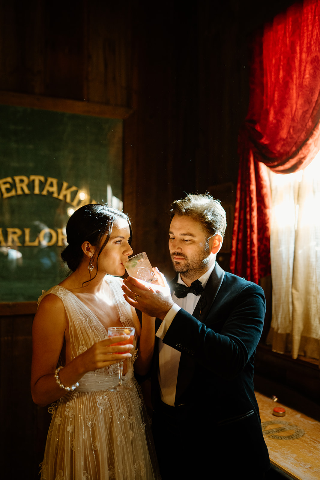 bride and groom drink cocktails at 1880 Union Hotel in Los Alamos, Ca photography by Cobblestone