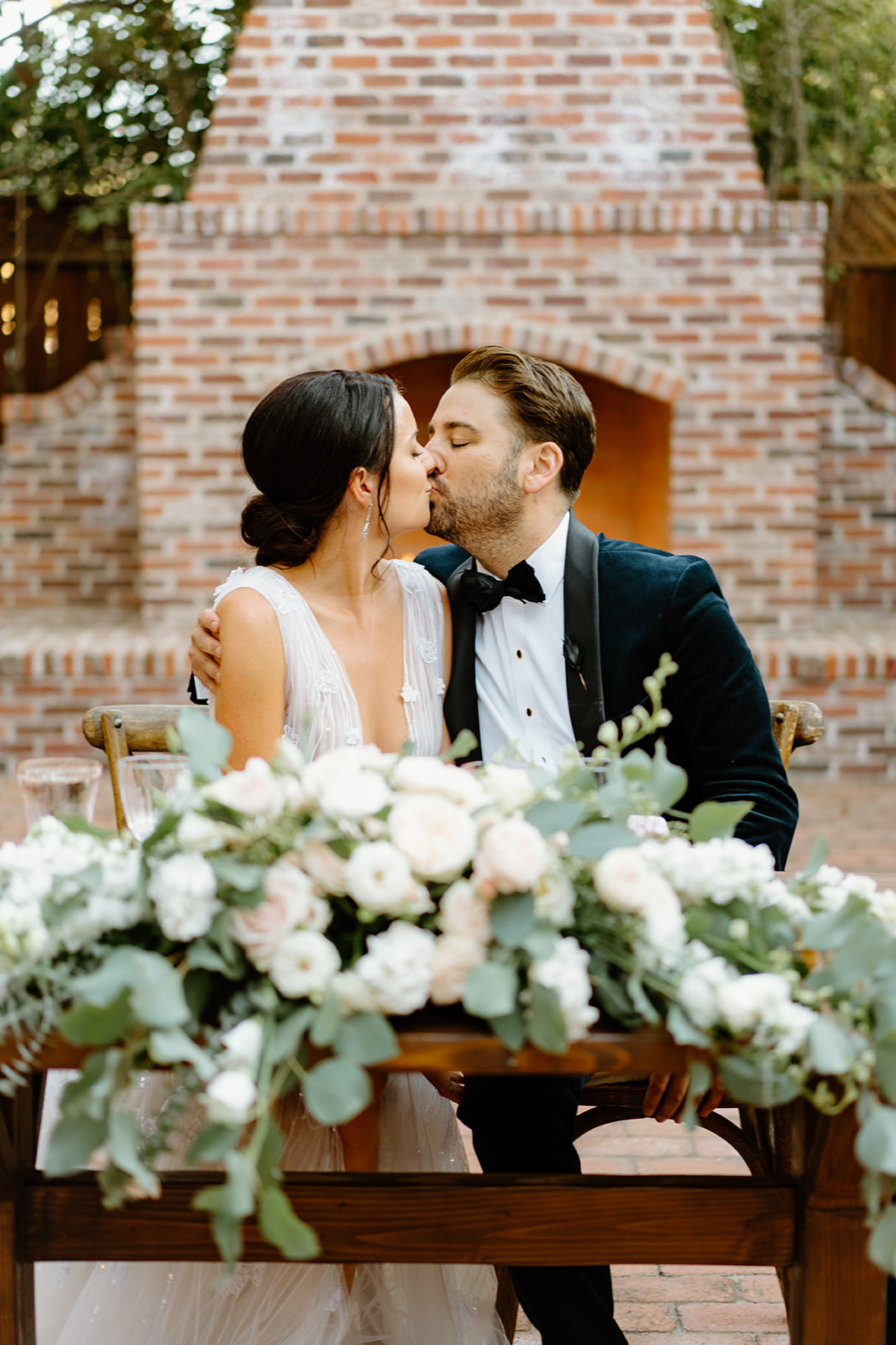 bride and groom at dinner table at 1880 Union Hotel in Los Alamos, Ca photography by Cobblestone