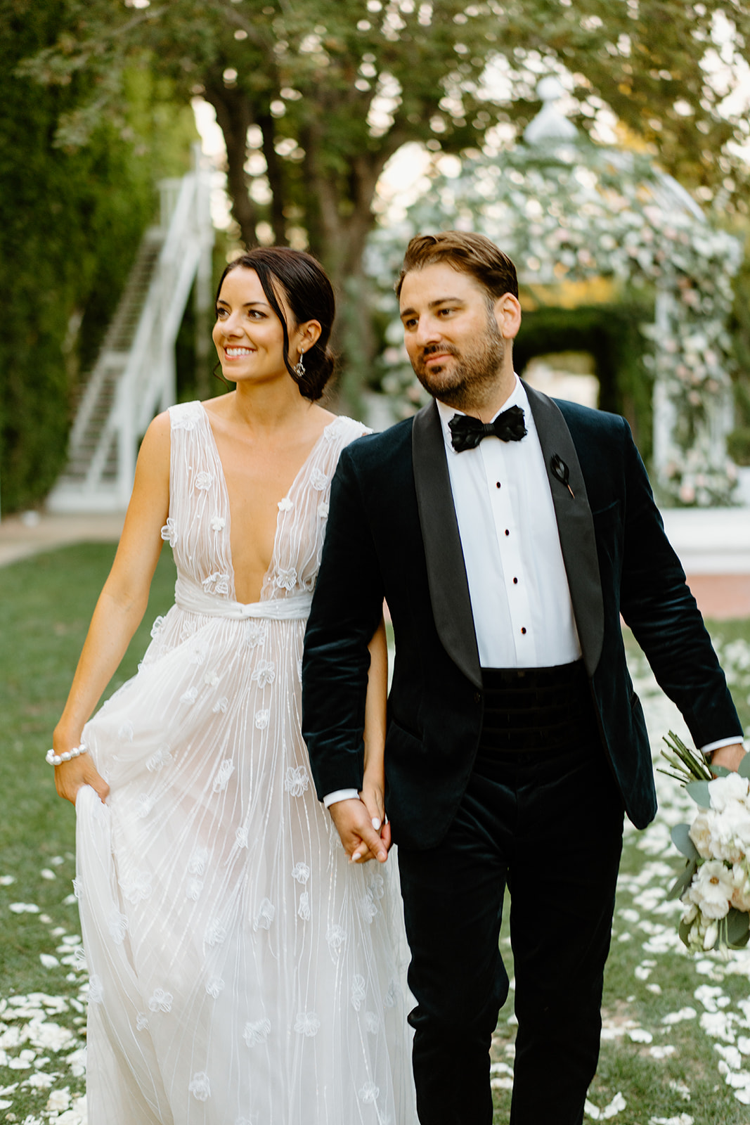 bride and groom under flower arch at 1880 Union Hotel in Los Alamos, Ca photography by Cobblestone