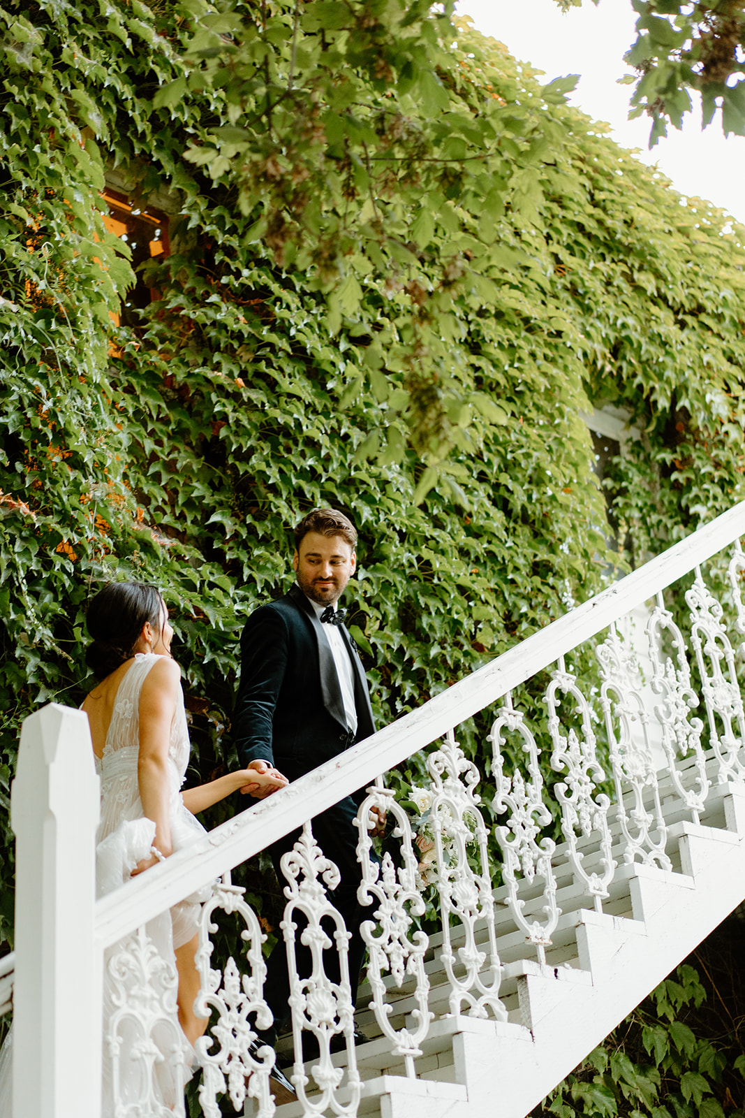 bride and groom walk up steps at 1880 Union Hotel in Los Alamos, Ca photography by Cobblestone