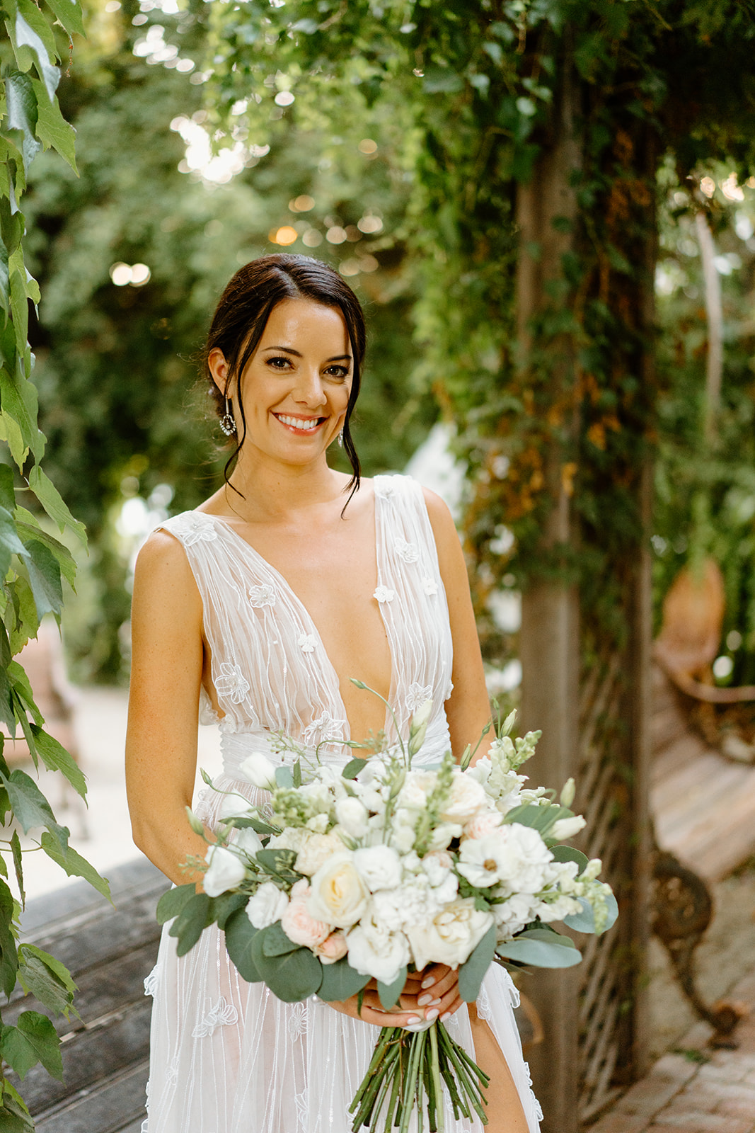 bride poses with florals at 1880 Union Hotel in Los Alamos, Ca photography by Cobblestone