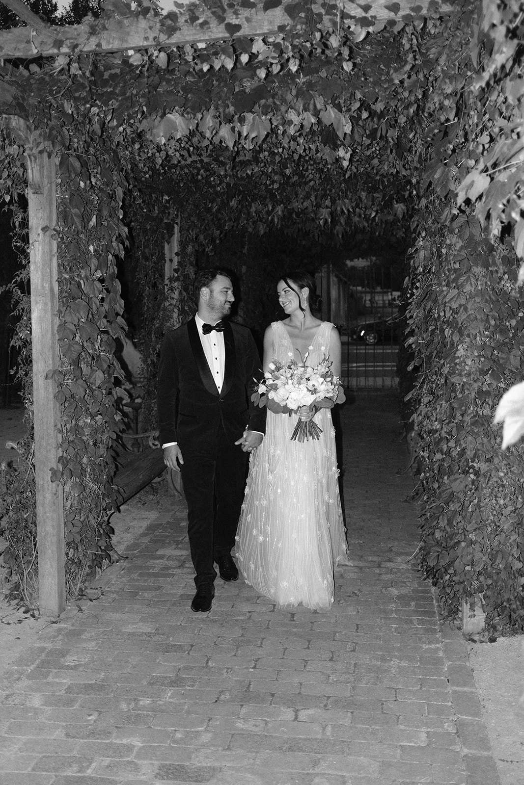 bride and groom walk 1880 Union Hotel in Los Alamos, Ca photography by Cobblestone