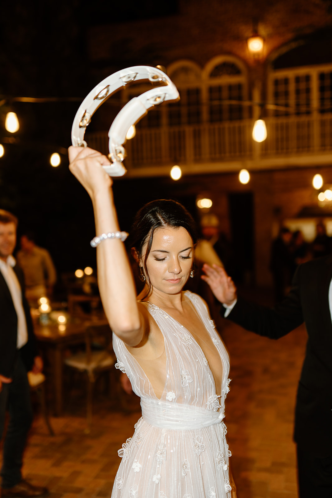bride dances with tambourine at wedding at 1880 Union Hotel in Los Alamos, Ca photography by Cobblestone
