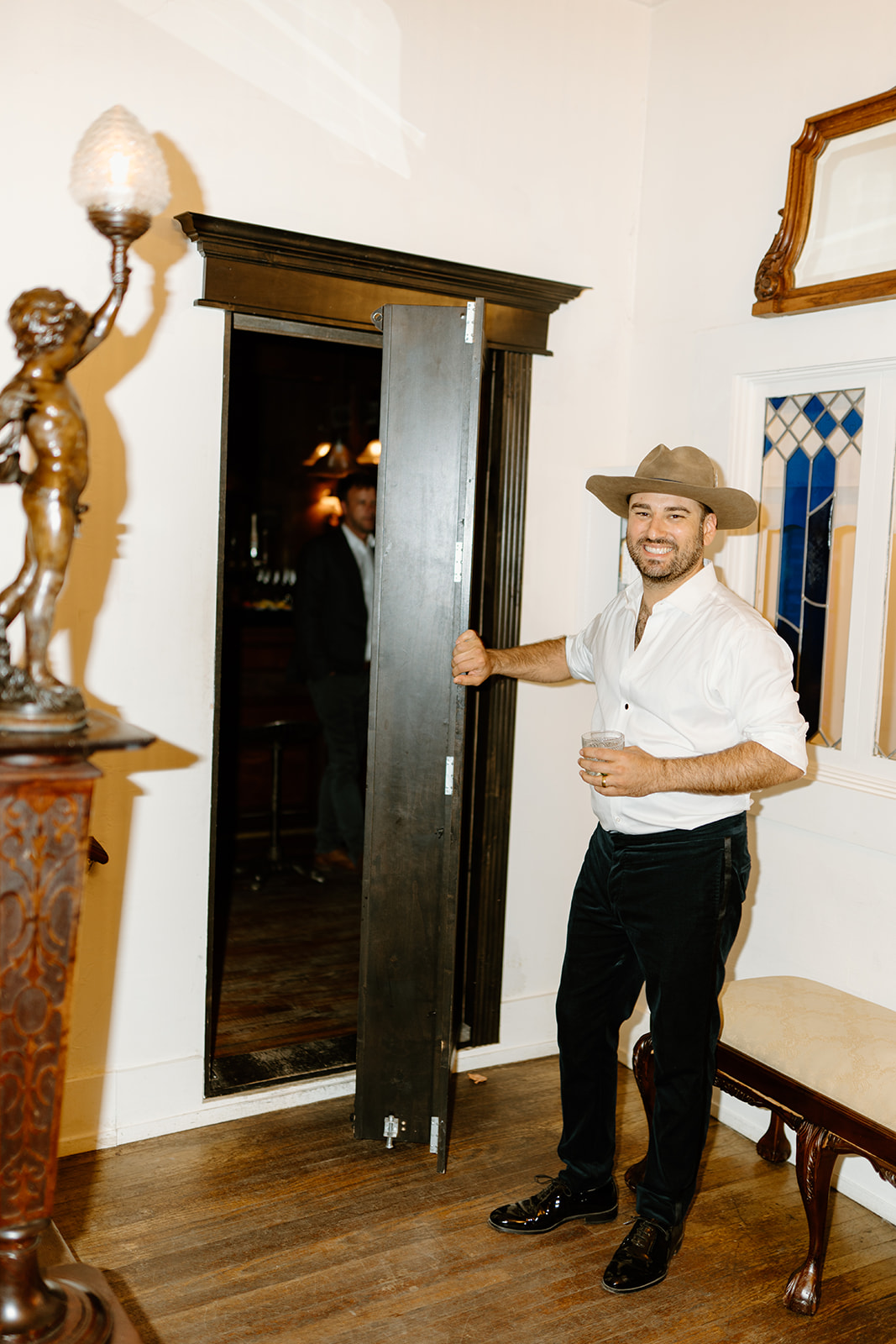 groom shows speakeasy at 1880 Union Hotel in Los Alamos, Ca photography by Cobblestone
