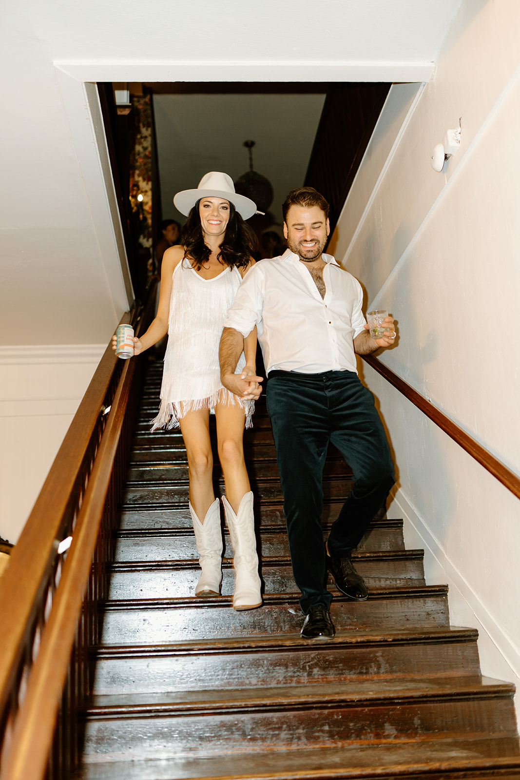 bride and groom walk steps to go to speakeasy at 1880 Union Hotel in Los Alamos, Ca photography by Cobblestone