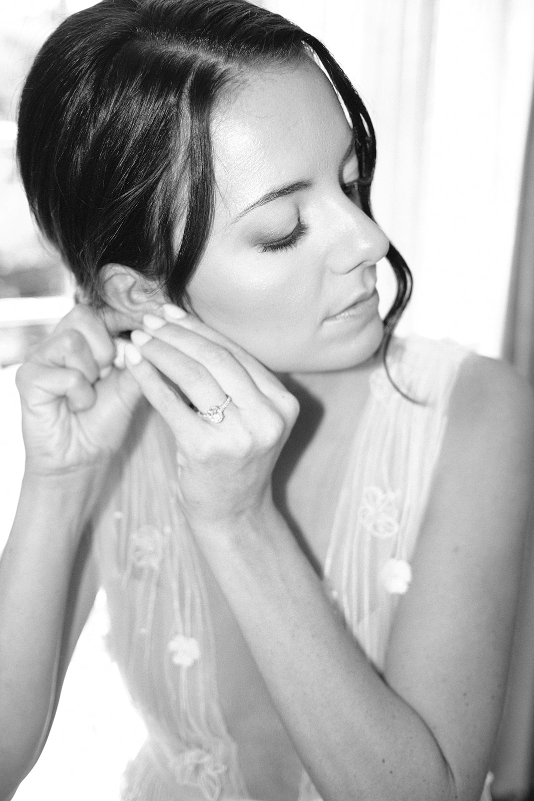 bride puts on earrings at wedding at 1880 Union Hotel in Los Alamos, Ca photography by Cobblestone
