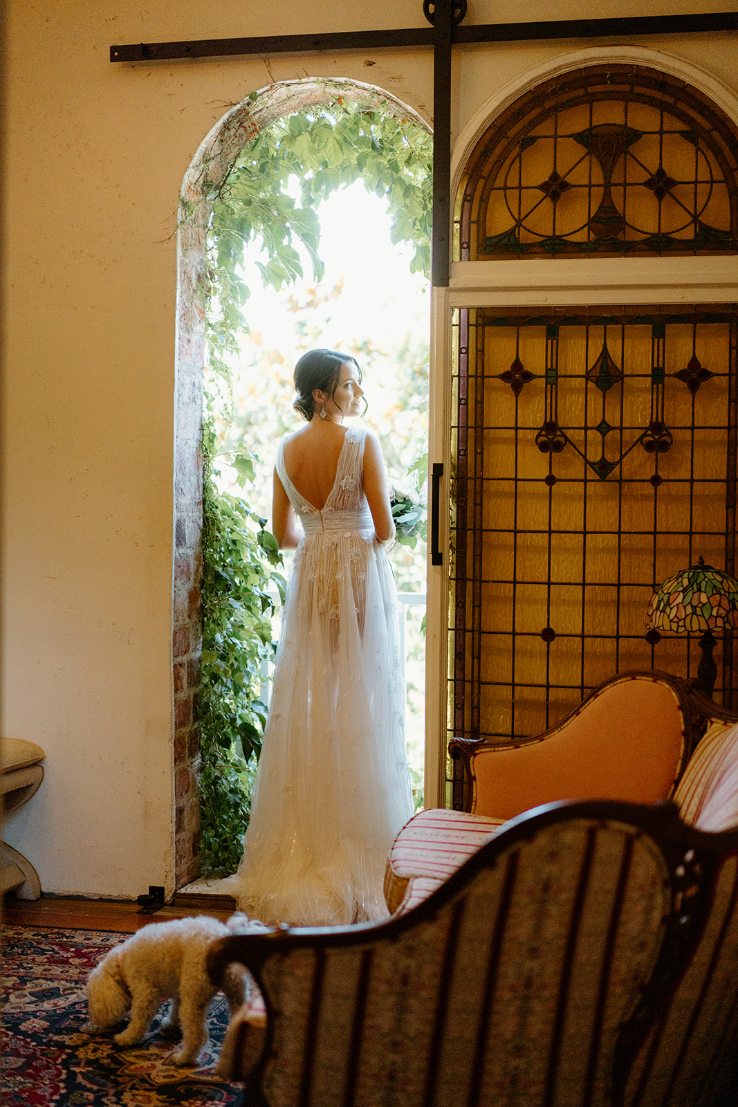 bride looks out window at wedding at 1880 Union Hotel in Los Alamos, Ca photography by Cobblestone