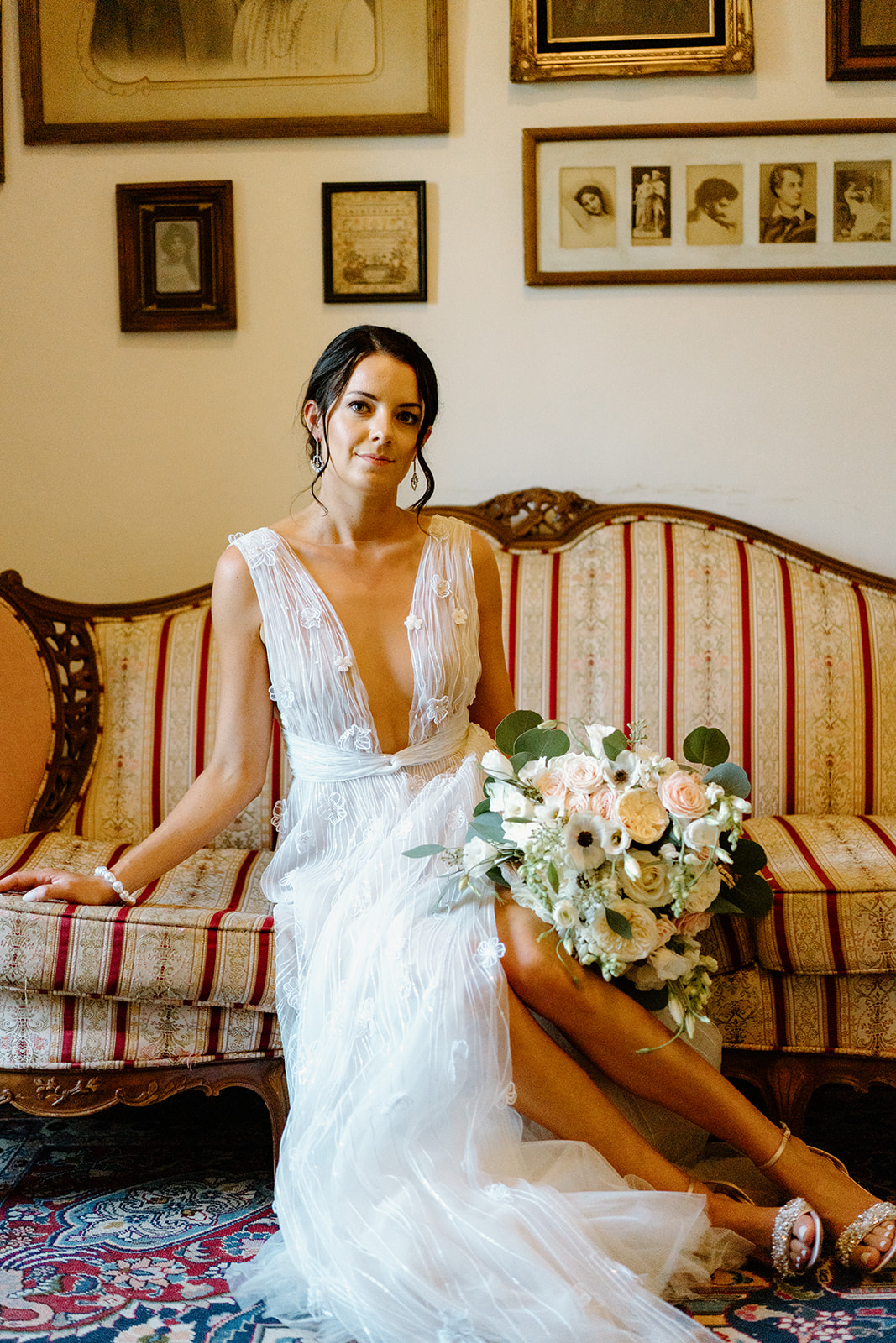 bride poses on couch at wedding at 1880 Union Hotel in Los Alamos, Ca photography by Cobblestone