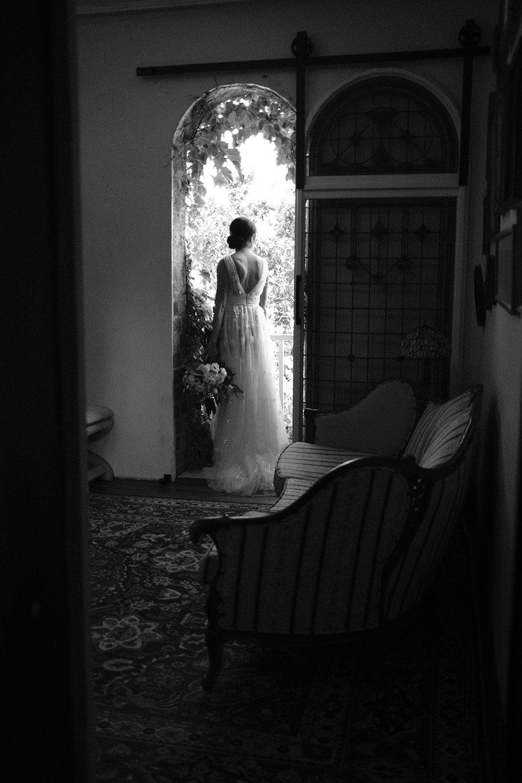bride looks out window at wedding at 1880 Union Hotel in Los Alamos, Ca photography by Cobblestone