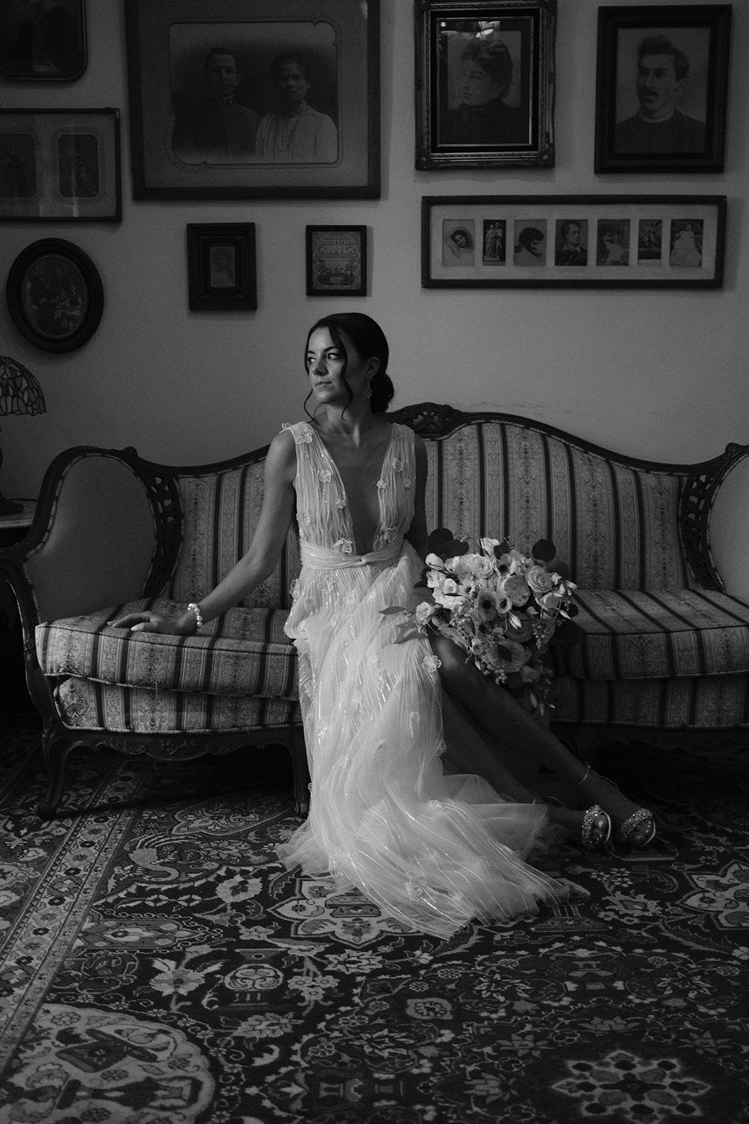 bride poses on couch at wedding at 1880 Union Hotel in Los Alamos, Ca photography by Cobblestone
