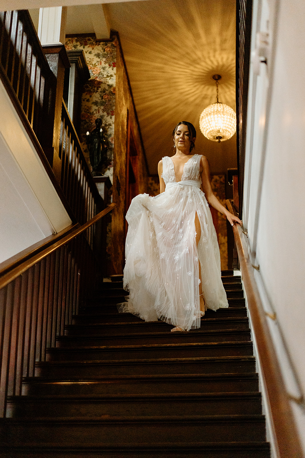 bride walks down stairs to wedding at 1880 Union Hotel in Los Alamos, Ca photography by Cobblestone