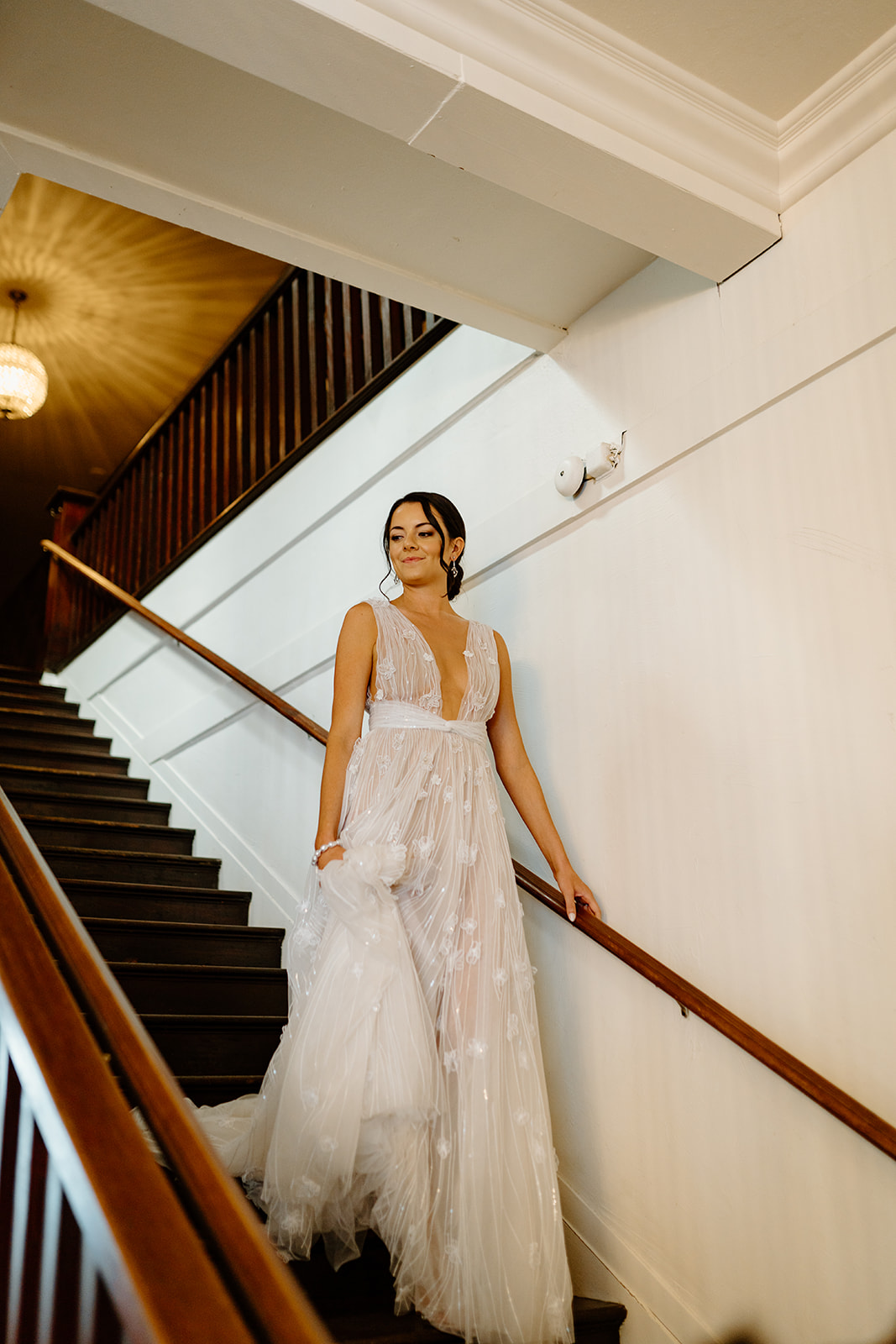 bride walks down stairs to wedding at 1880 Union Hotel in Los Alamos, Ca photography by Cobblestone
