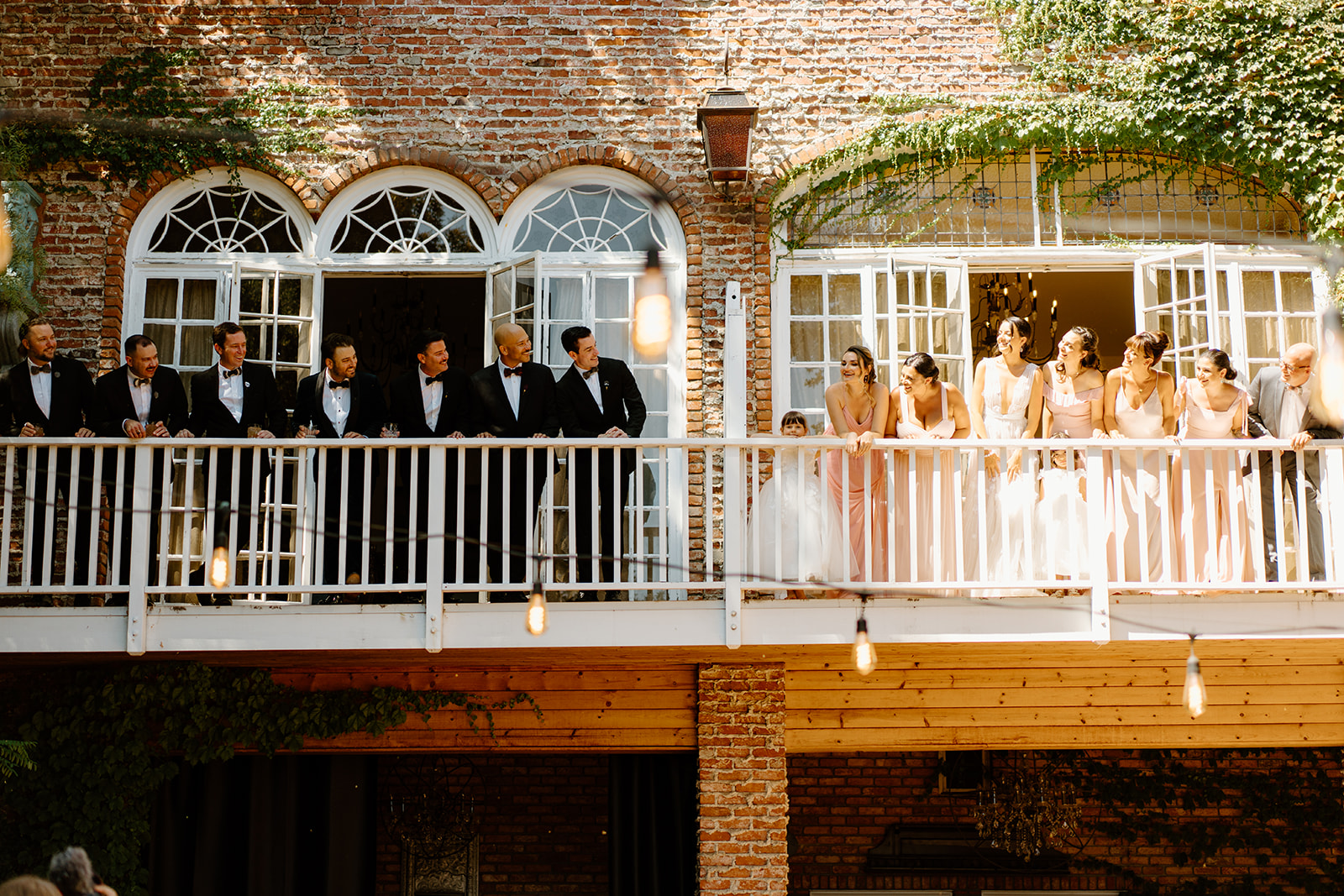 bridal party on balcony at wedding at 1880 Union Hotel in Los Alamos, Ca photography by Cobblestone