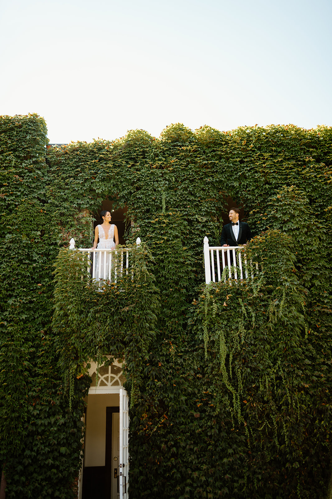 bride and groom on balcony at wedding at 1880 Union Hotel in Los Alamos, Ca photography by Cobblestone