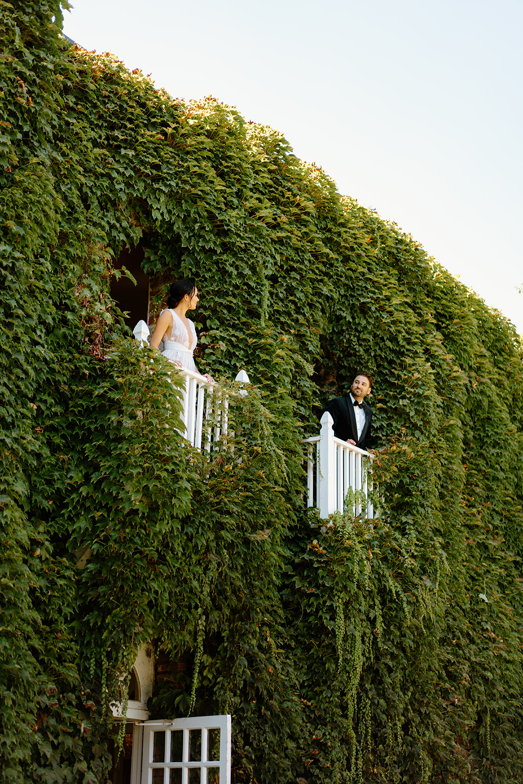 bride and groom on balcony at wedding at 1880 Union Hotel in Los Alamos, Ca photography by Cobblestone