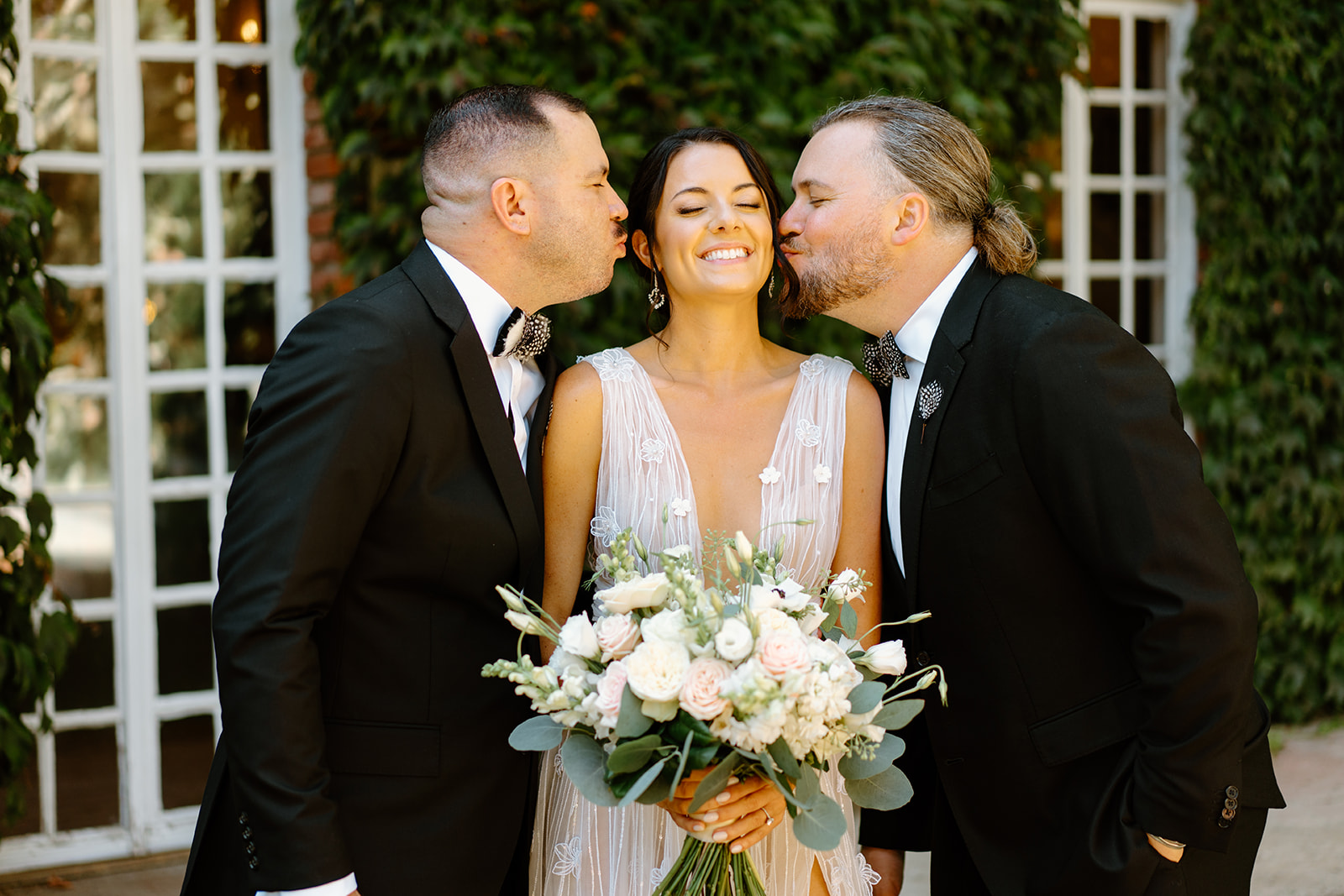 bride with groomsmen kissing her at wedding at 1880 Union Hotel in Los Alamos, Ca photography by Cobblestone