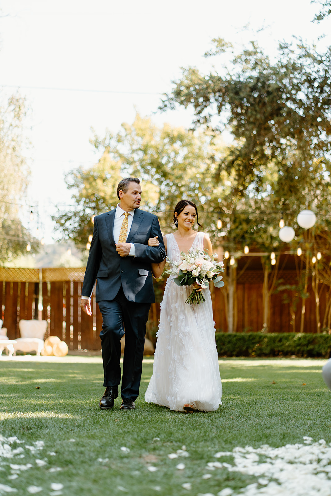 bride walks down isle at 1880 Union Hotel in Los Alamos, Ca photography by Cobblestone