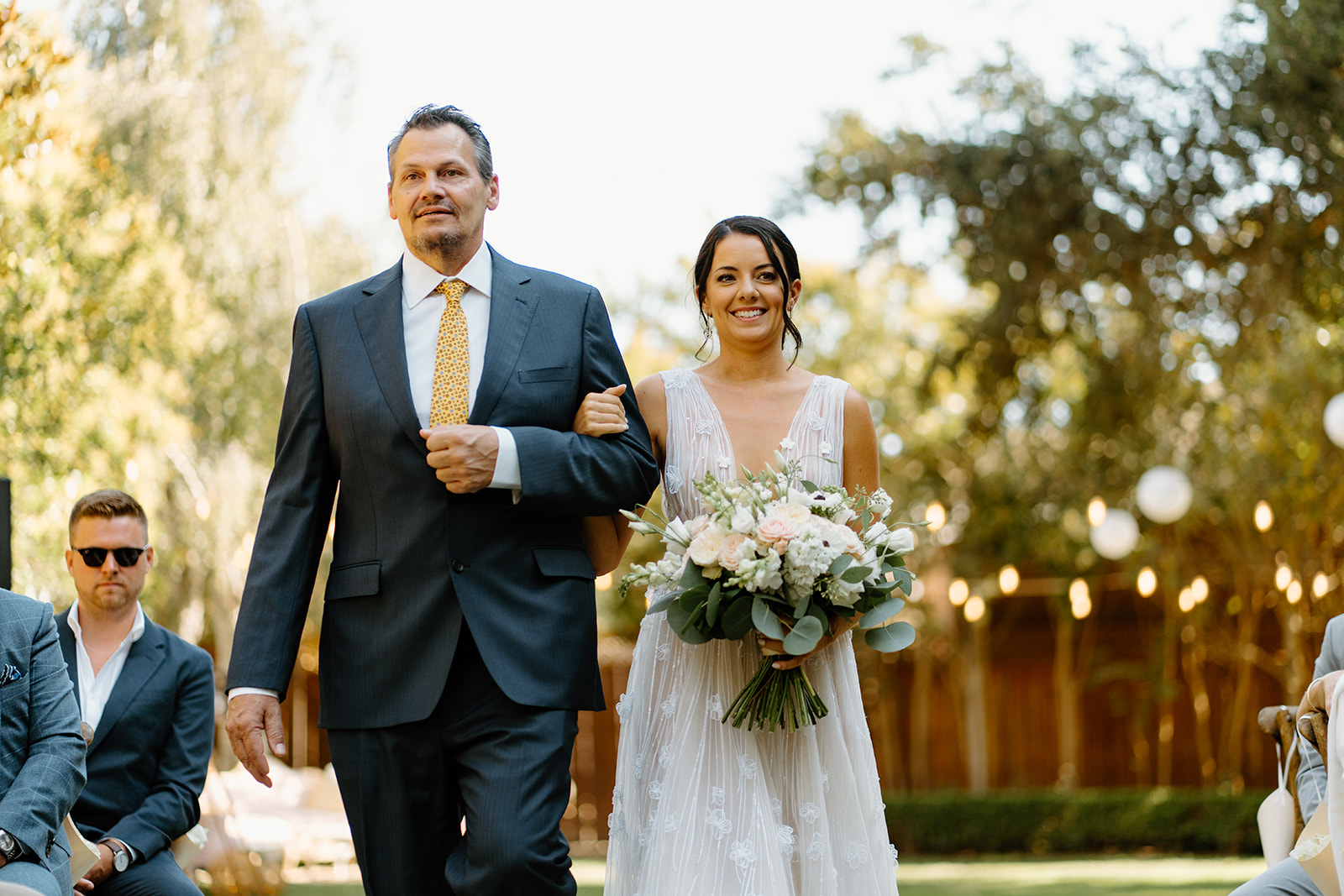 bride and father walk down isle at 1880 Union Hotel in Los Alamos, Ca photography by Cobblestone