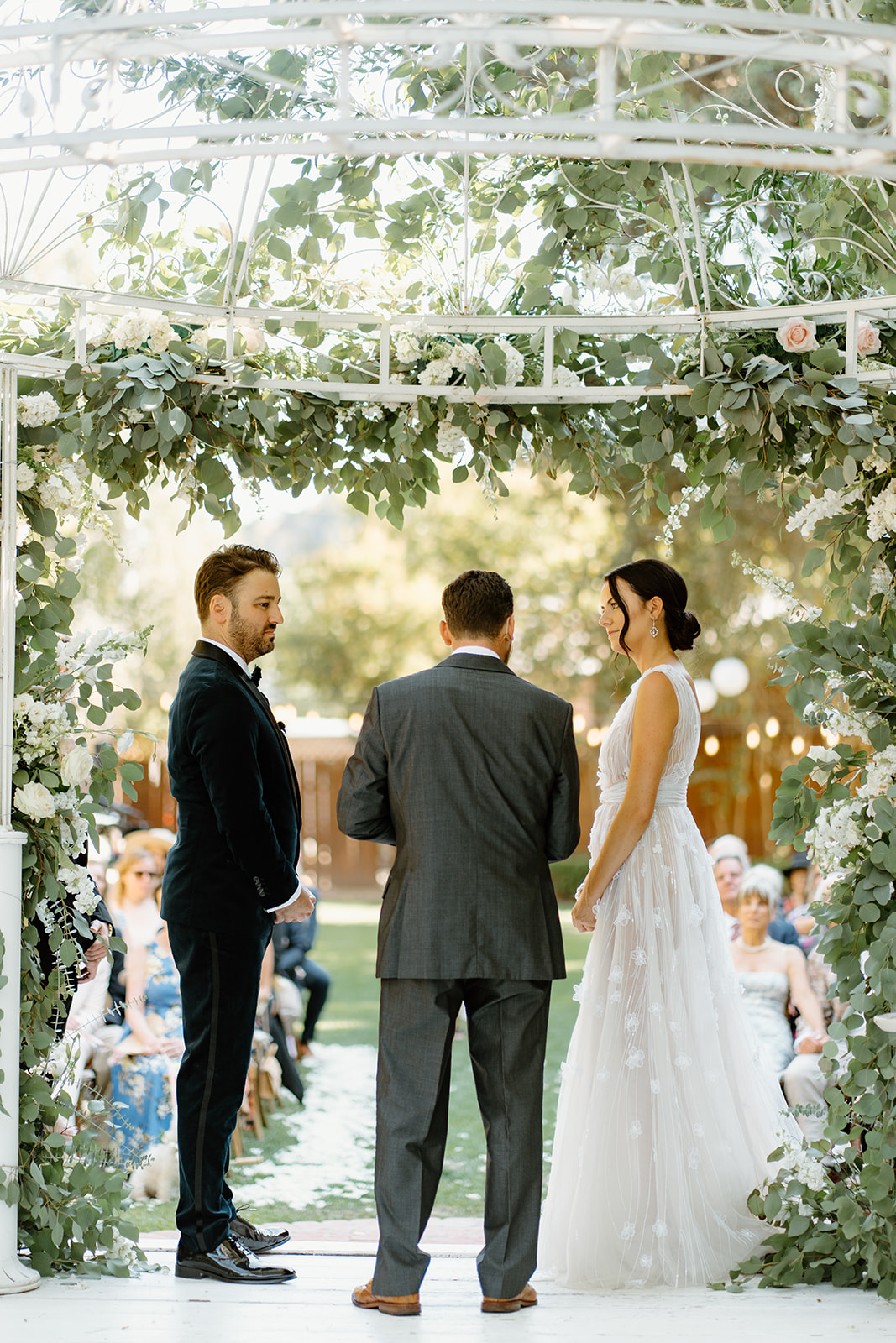 bride and groom under arch during wedding at 1880 Union Hotel in Los Alamos, Ca photography by Cobblestone