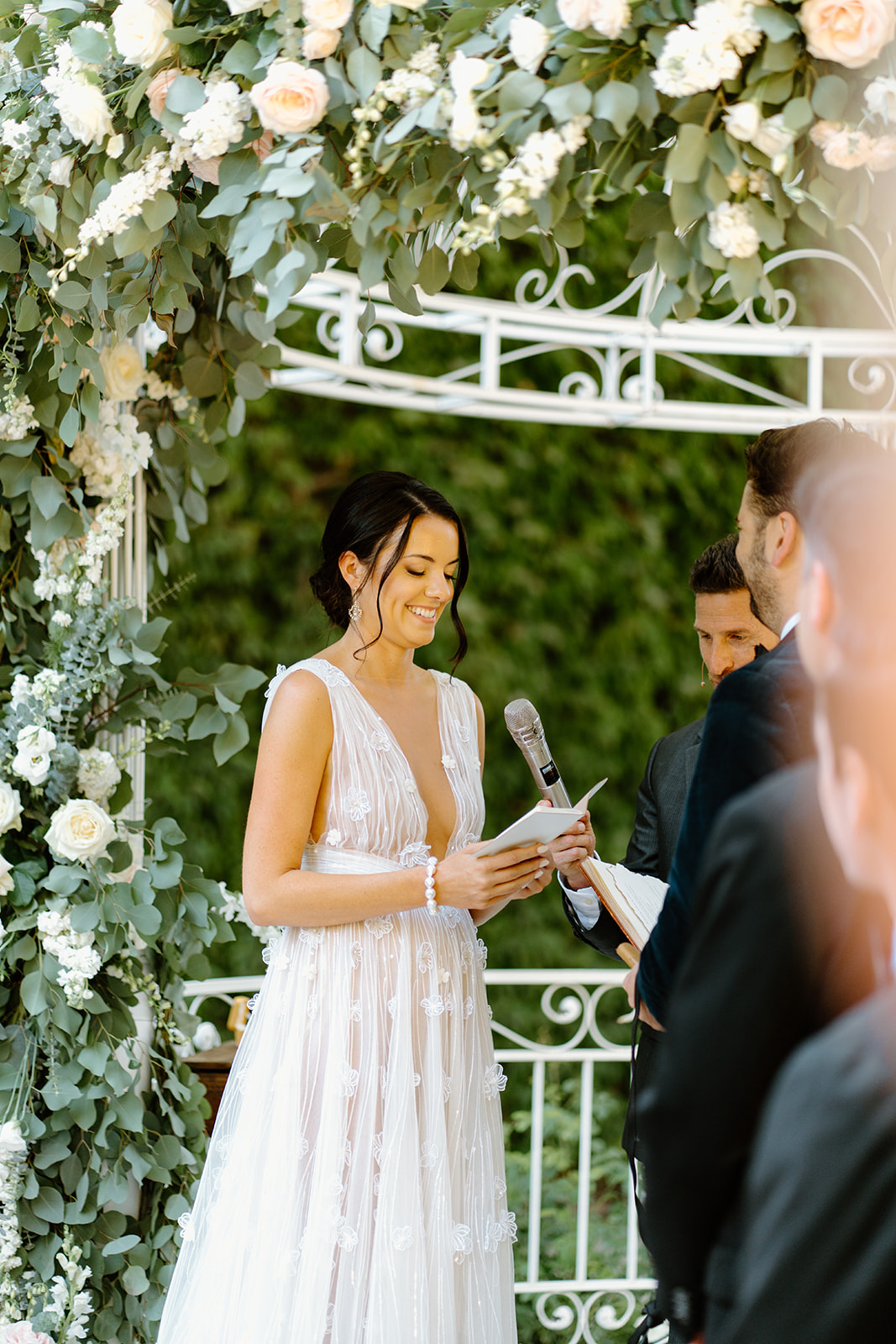 bride and groom under arch during wedding at 1880 Union Hotel in Los Alamos, Ca photography by Cobblestone