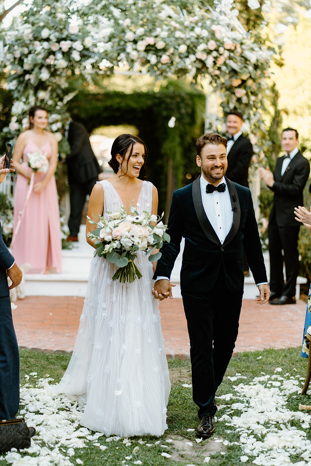 bride and groom walk down the isle at 1880 Union Hotel in Los Alamos, Ca photography by Cobblestone