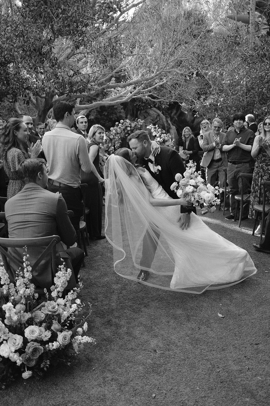 dip kiss by bride and groom at Oceanside California, photography by Cobblestone Weddings