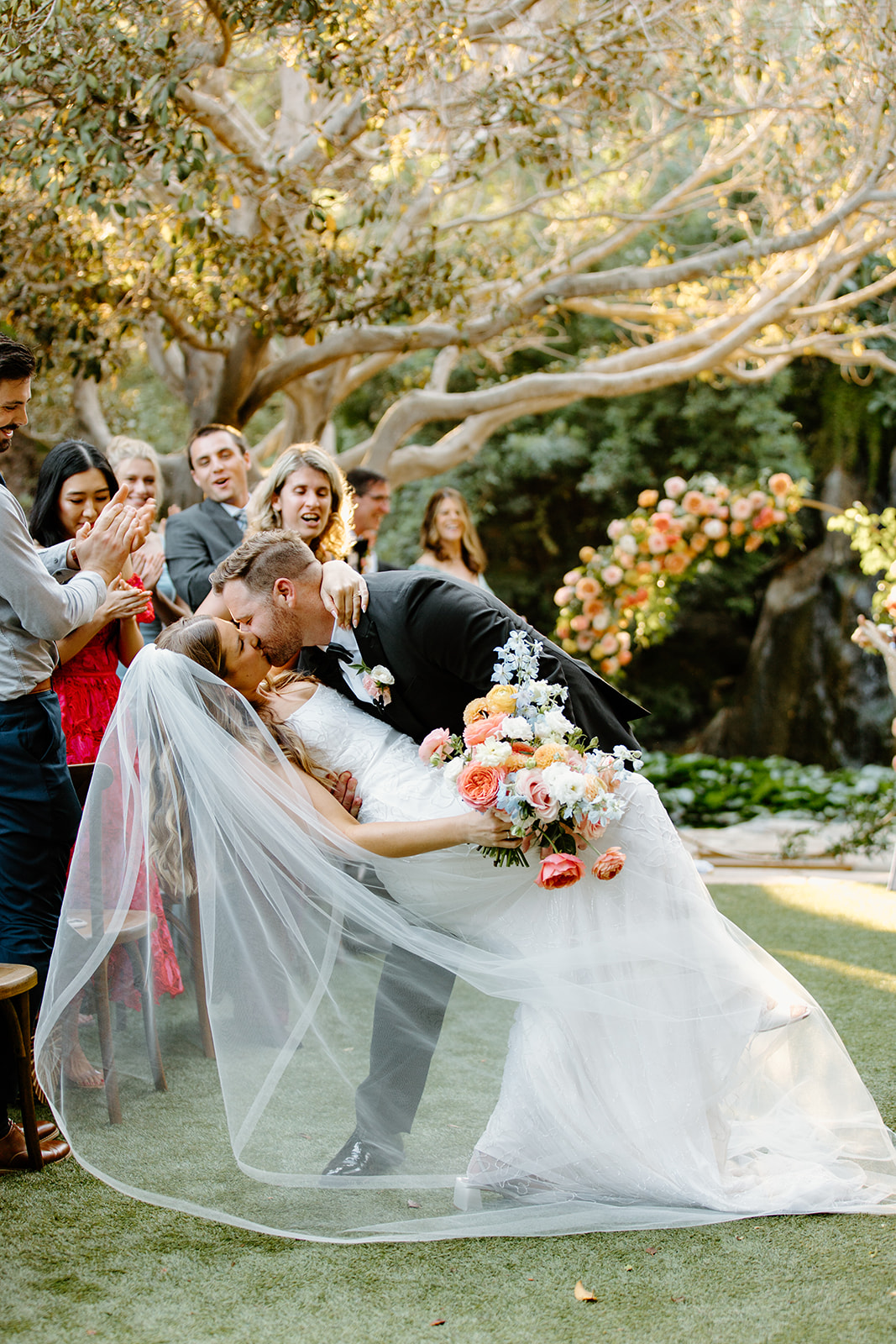 dip kiss by bride and groom at Oceanside California, photography by Cobblestone Weddings