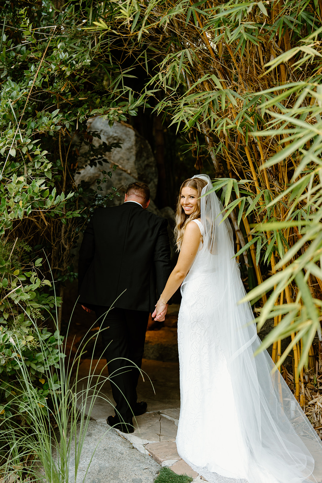 Bride and groom walk grounds at Botanica Oceanside California, photography by Cobblestone Weddings