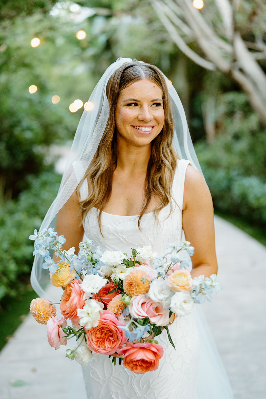bride with florals at wedding at Botanica, Oceanside California, photography by Cobblestone