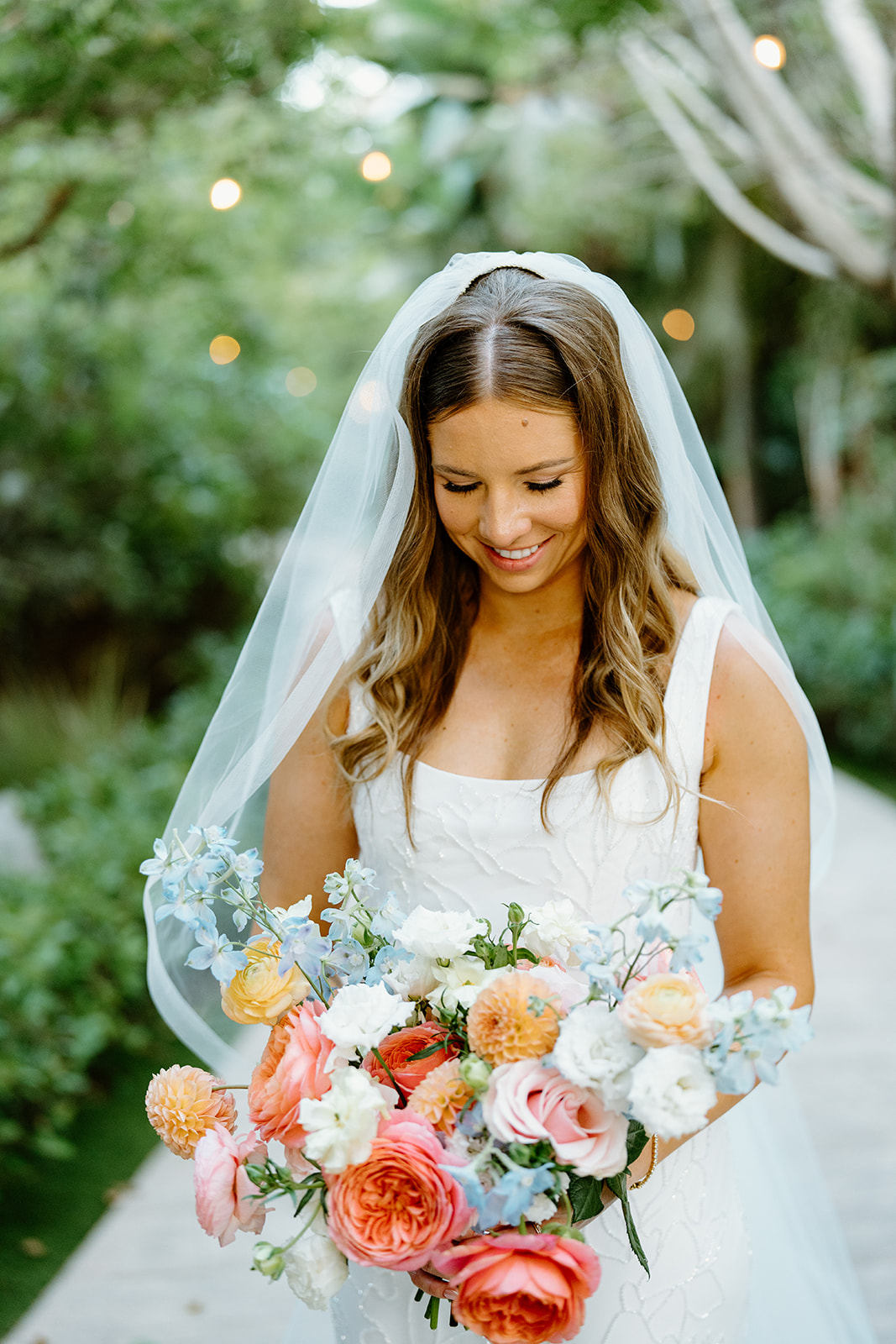 bride with florals at wedding at Botanica, Oceanside California, photography by Cobblestone