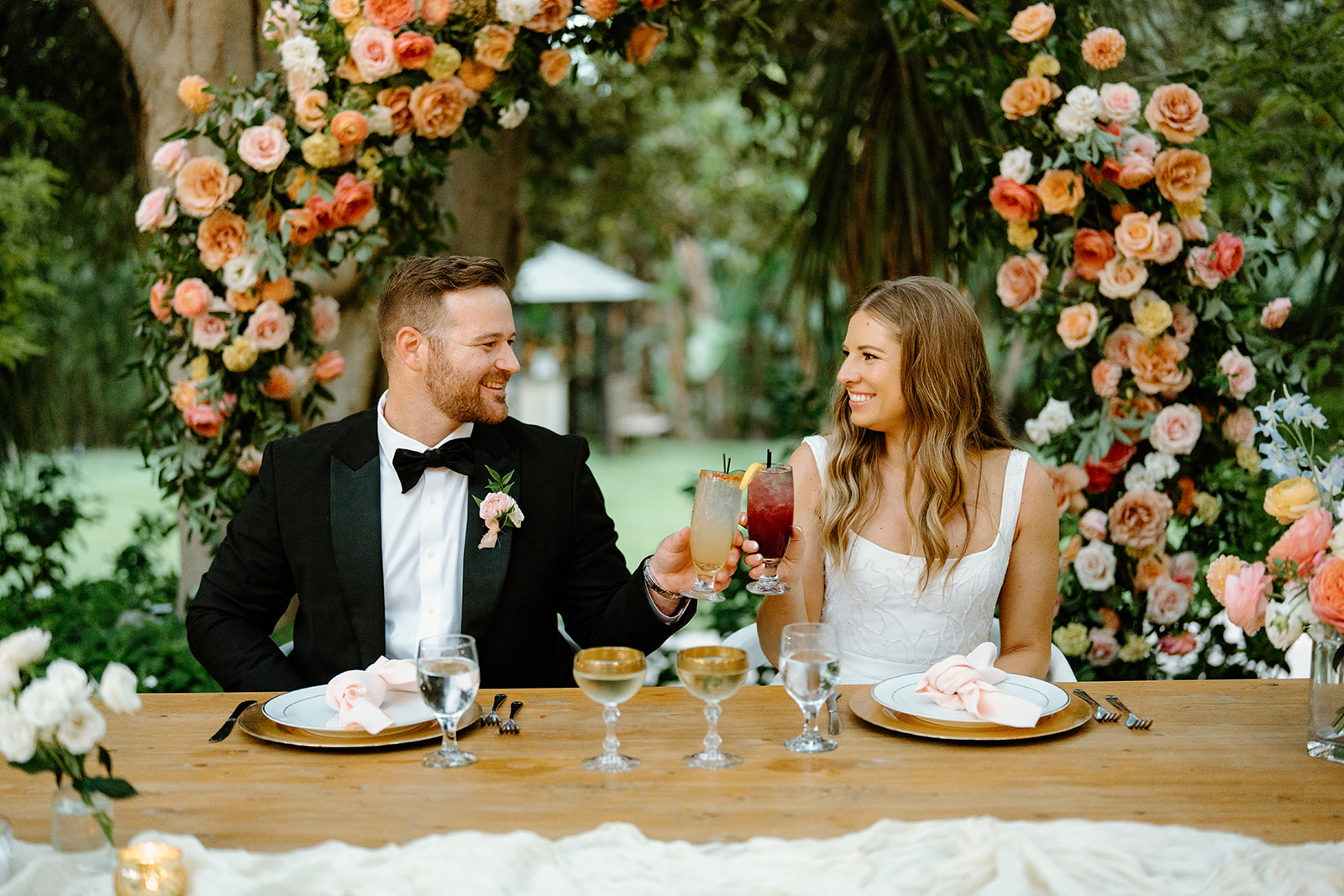 bride and groom cheers at wedding at Botanica, Oceanside California, photography by Cobblestone