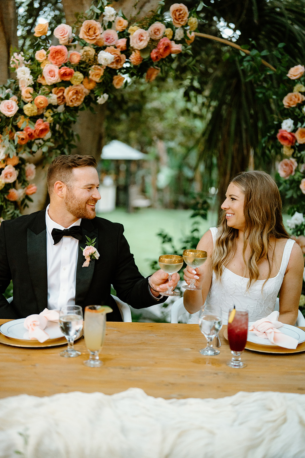 bride and groom cheers at wedding at Botanica, Oceanside California, photography by Cobblestone