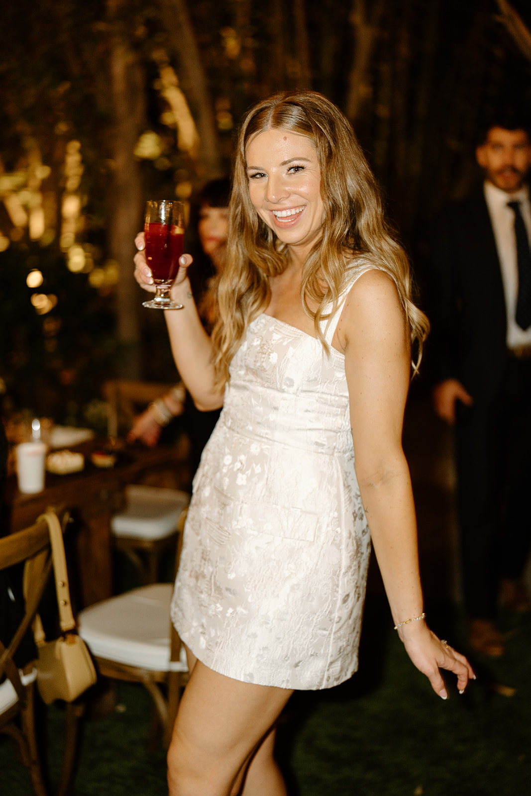 bride changes to cocktail dress at wedding at Botanica, Oceanside California, photography by Cobblestone