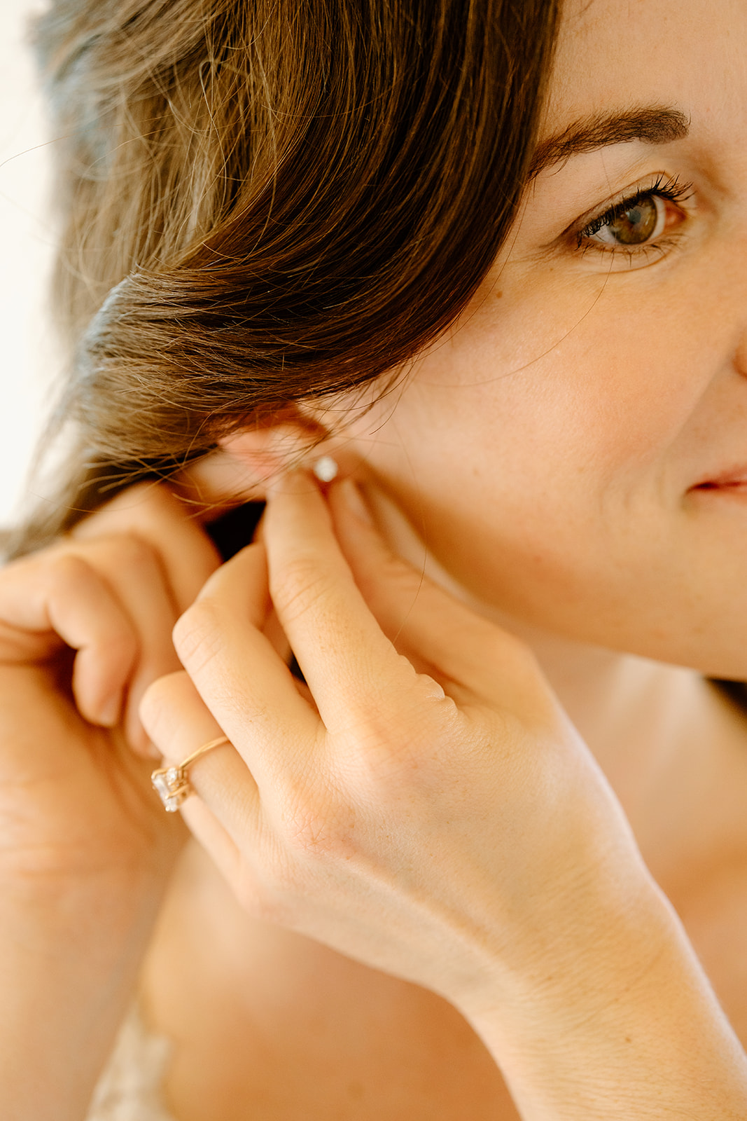 Bride puts in earring at Higuera Ranch, San Luis Obispo CA, photography by Cobblestone