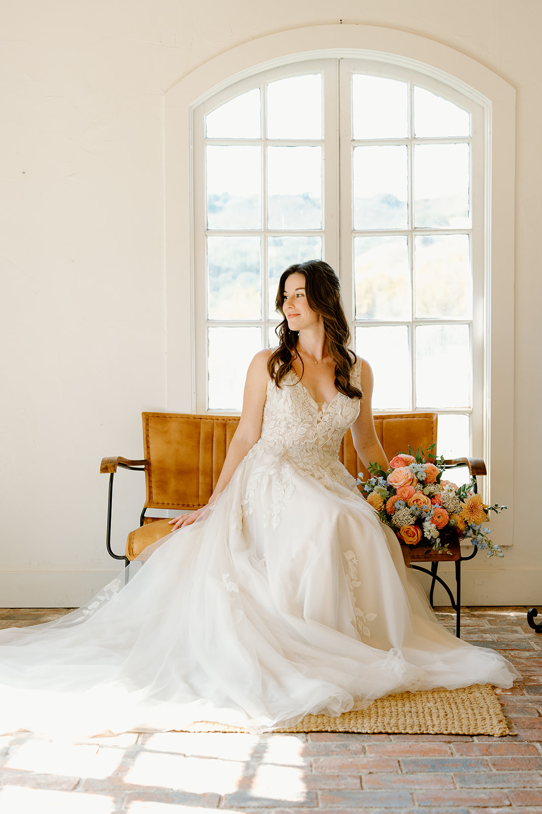Bride sitting looks out window at Higuera Ranch, San Luis Obispo CA, photography by Cobblestone